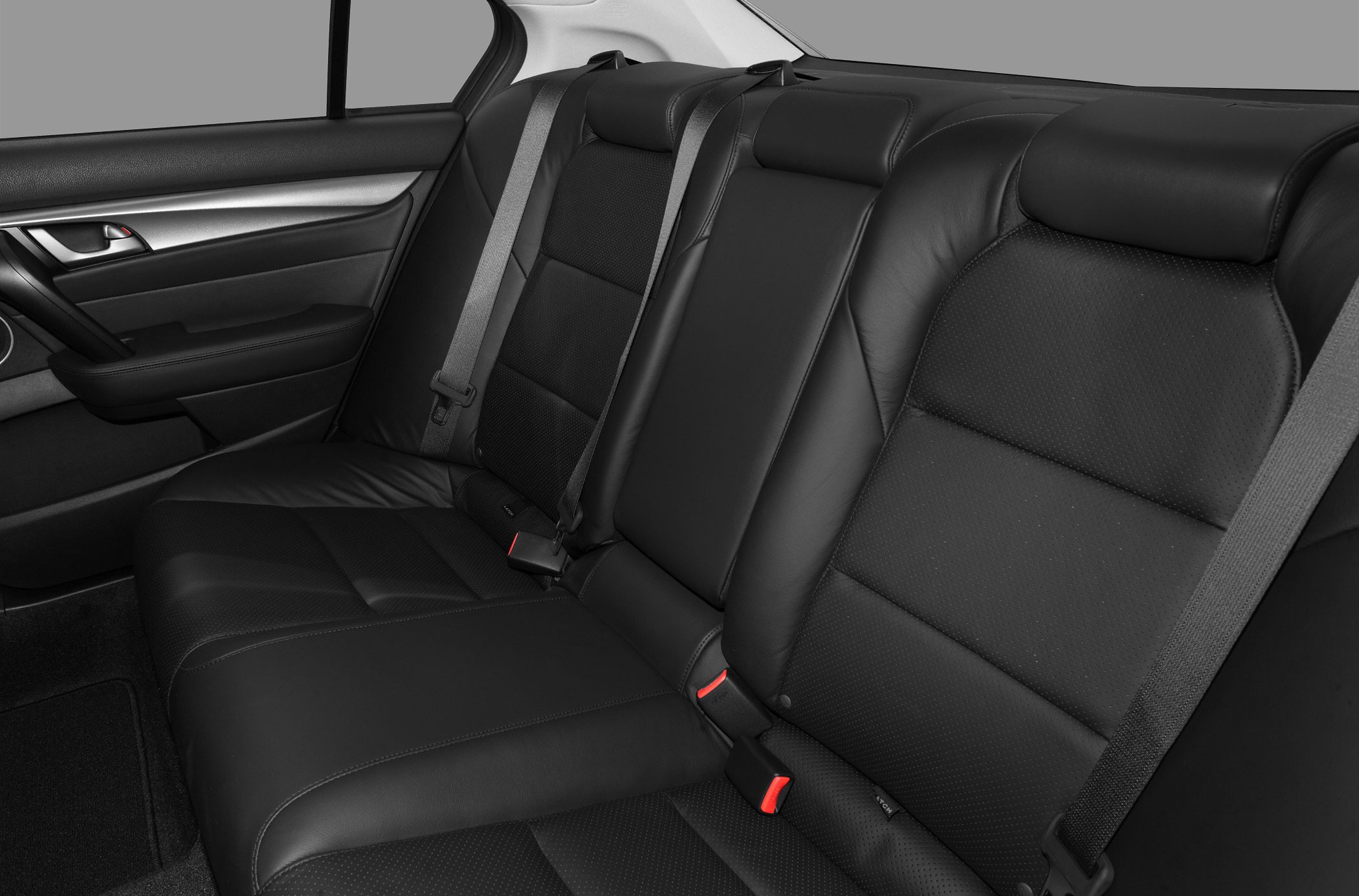 Rear leather seating with seatbelts in mid-size sedan interior