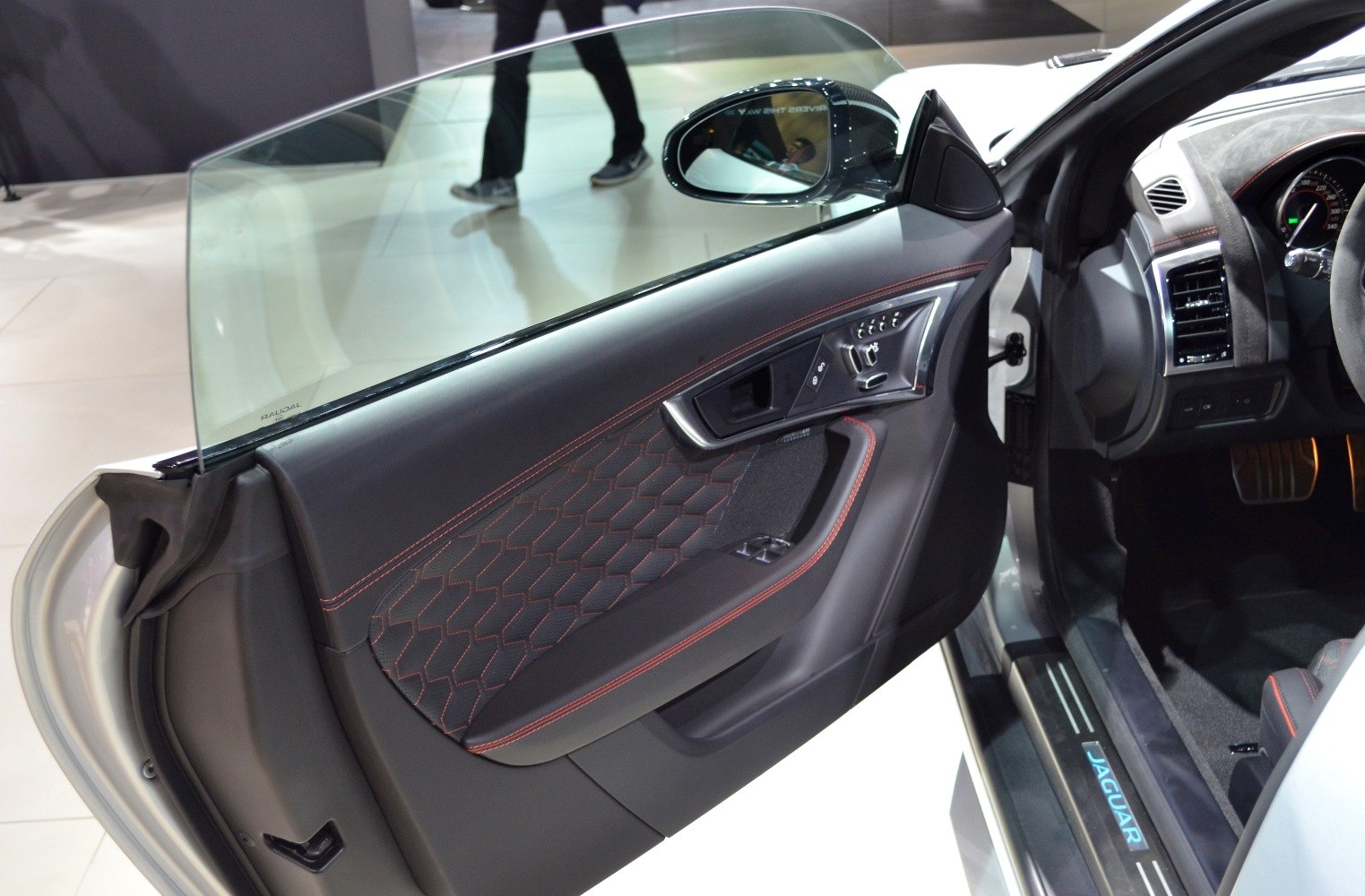 Door panel with red stitching and advanced controls