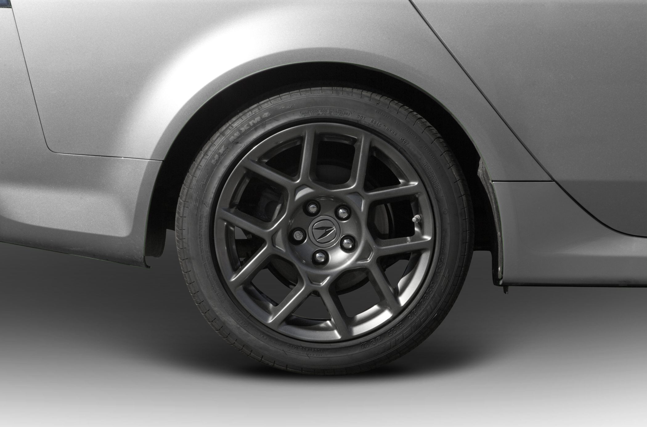 Close-up of alloy wheel and tire with Acura emblem on valve cap