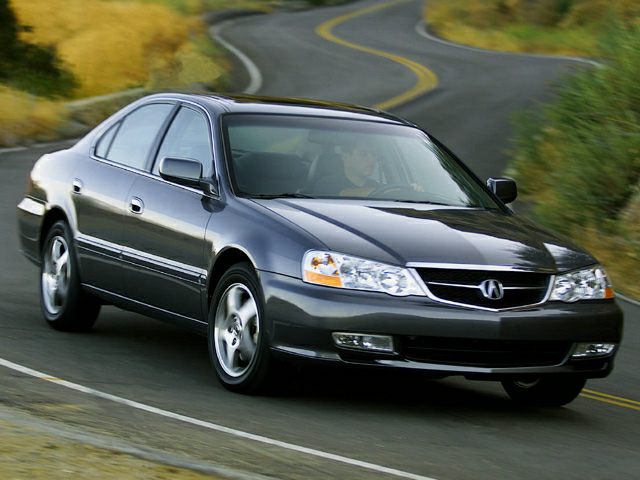 Gray sedan driving on a curvy road with aerodynamic body and alloy wheels