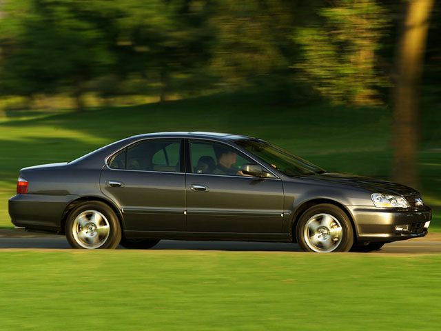 Sleek four-door sedan side view with alloy wheels in motion