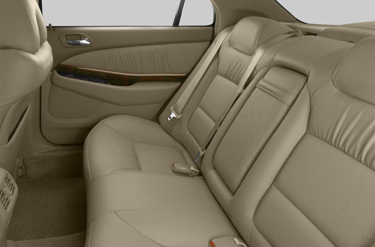 Tan leather rear seat with wood trim door panel and seat belts