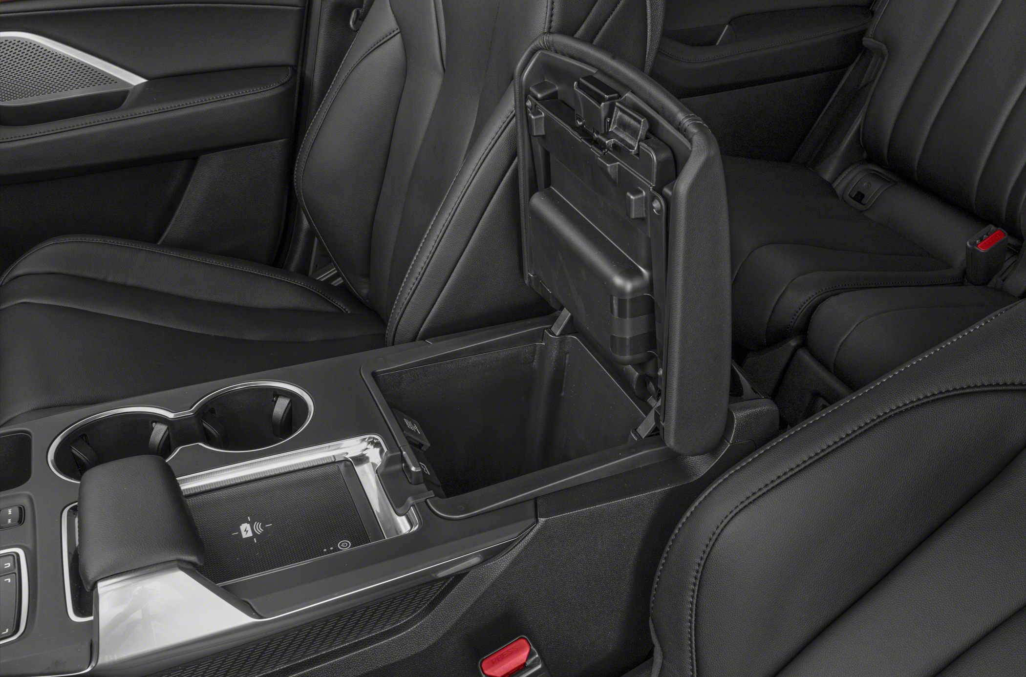 Center console storage compartment and wireless charging pad in black leather interior