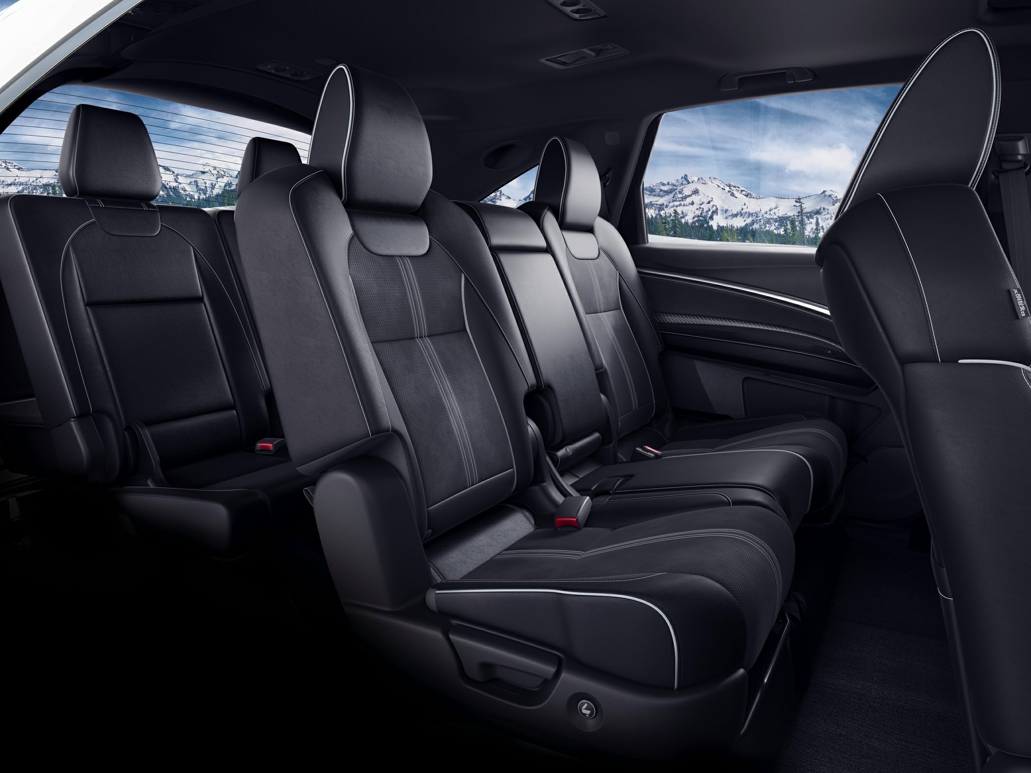 Luxurious black leather rear seats with detailed stitching and armrest