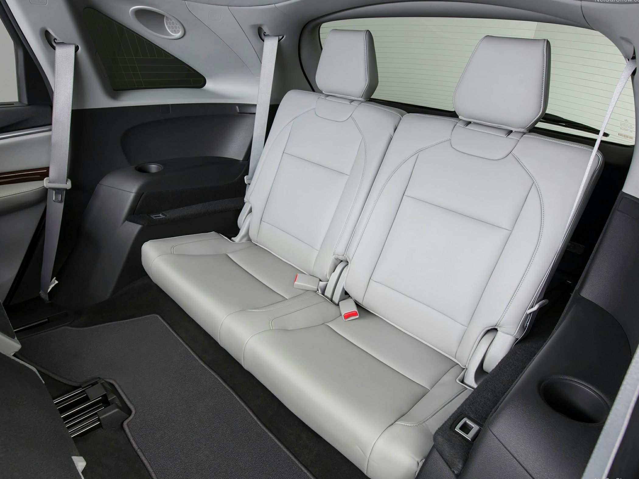 Spacious rear passenger seats with seat belts and cup holders