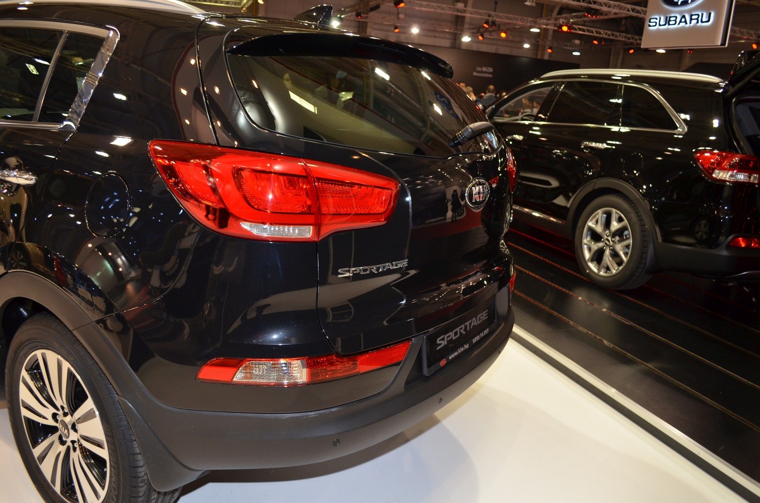 Rear section with distinctive red tail lights on black SUV.