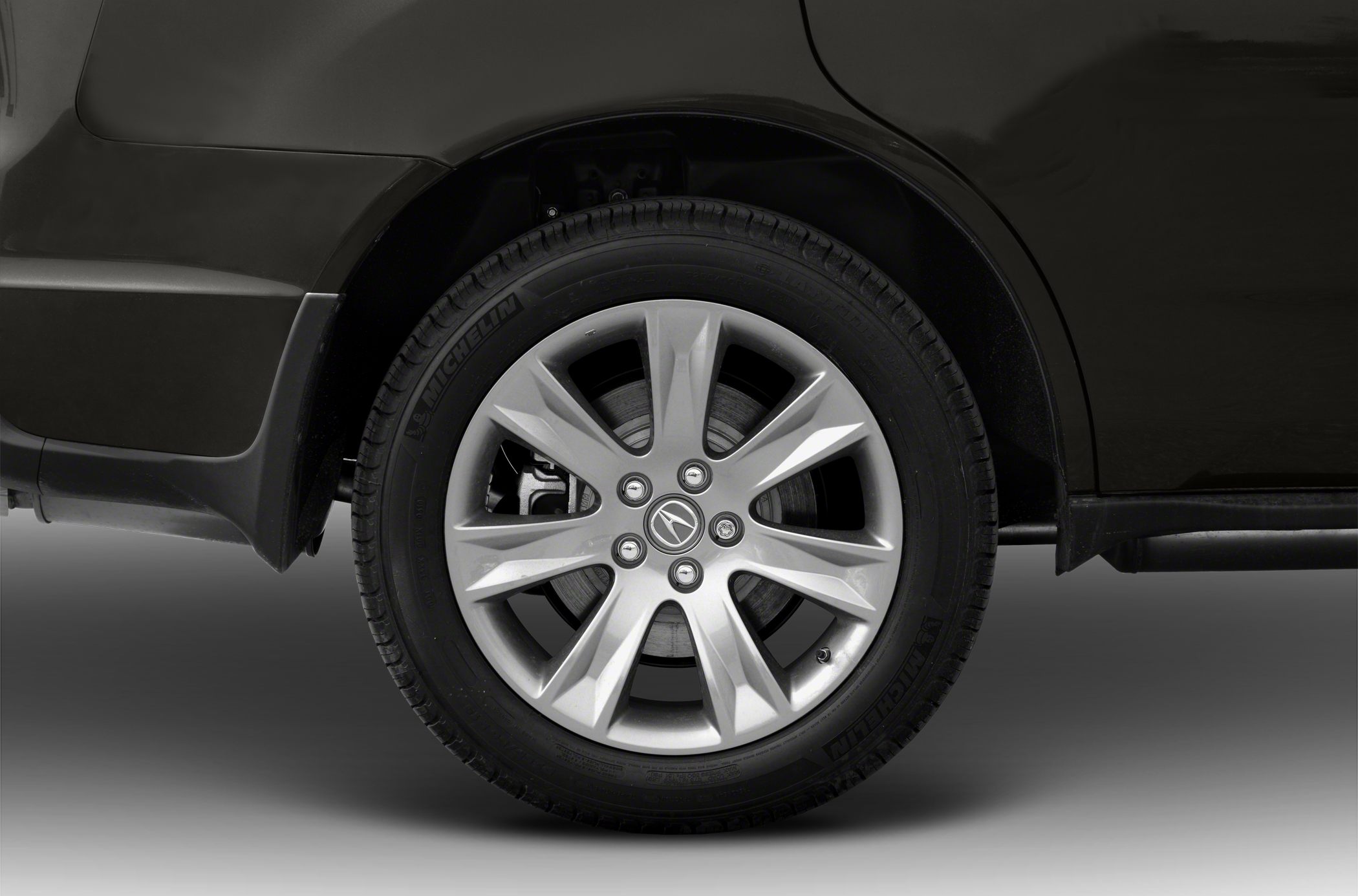Close-up of 7-spoke alloy wheel with Michelin tire and visible brake disc