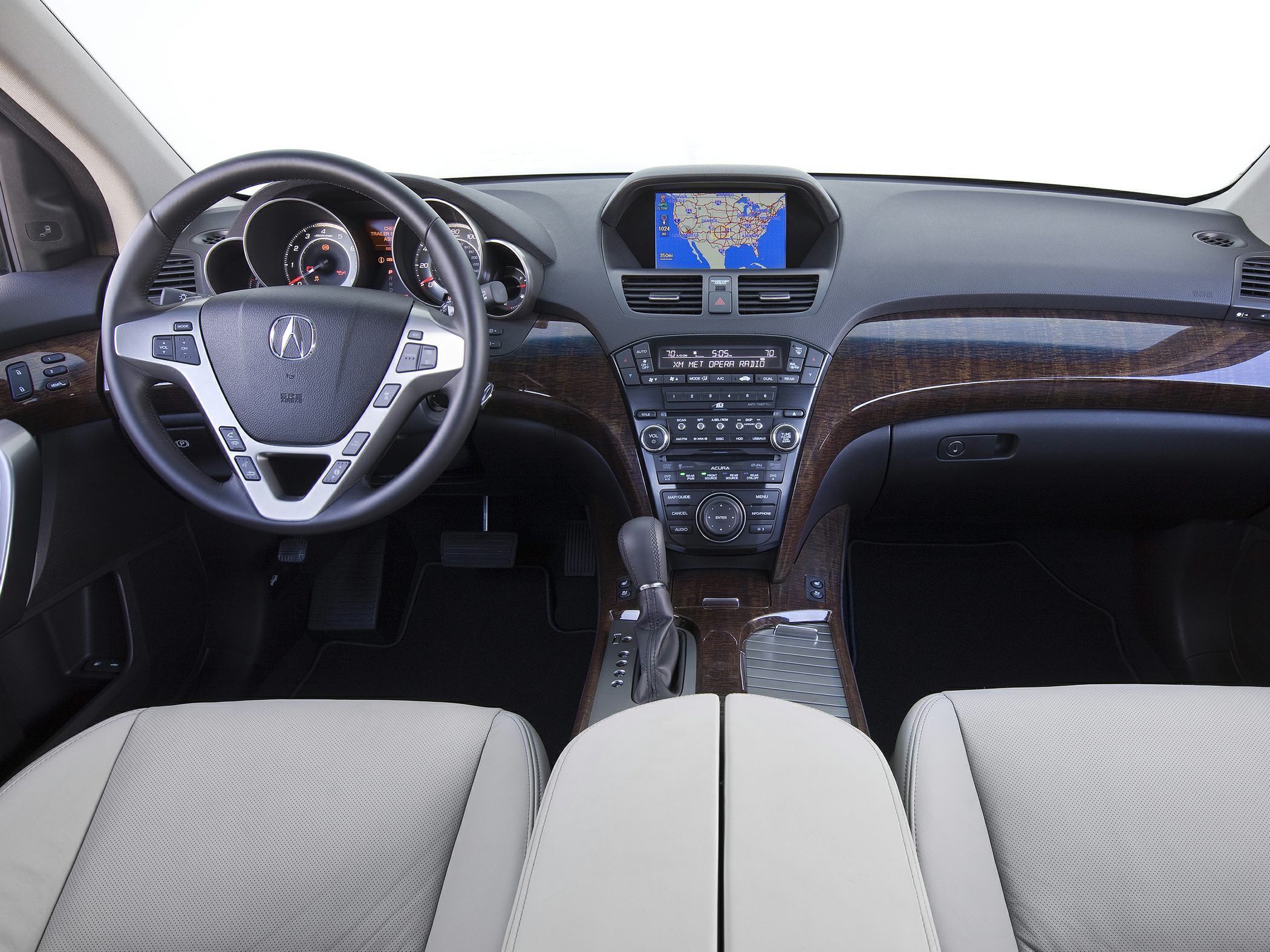 Dashboard and steering wheel with wood trim and navigation screen