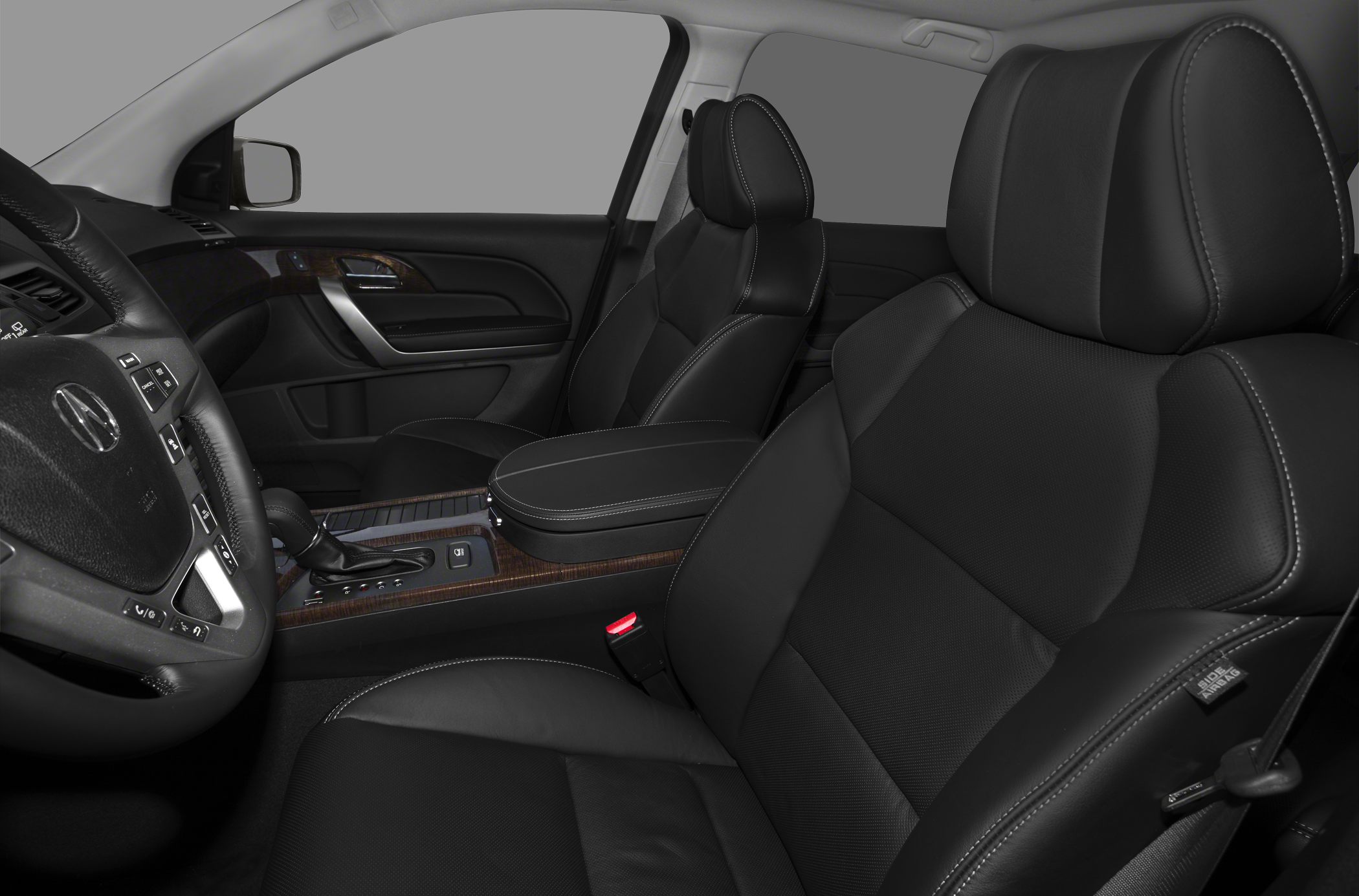 Black leather upholstery and wood-trimmed center console with steering wheel