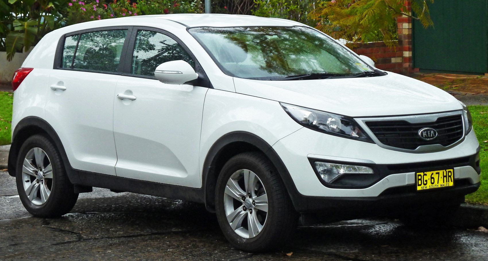 White compact SUV front-side view with sleek headlights and alloy wheels