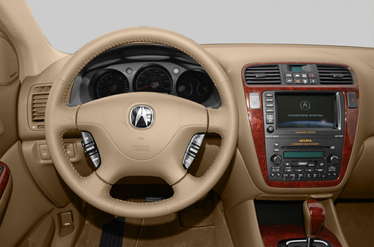 Beige steering wheel with controls and central navigation system with wood trim