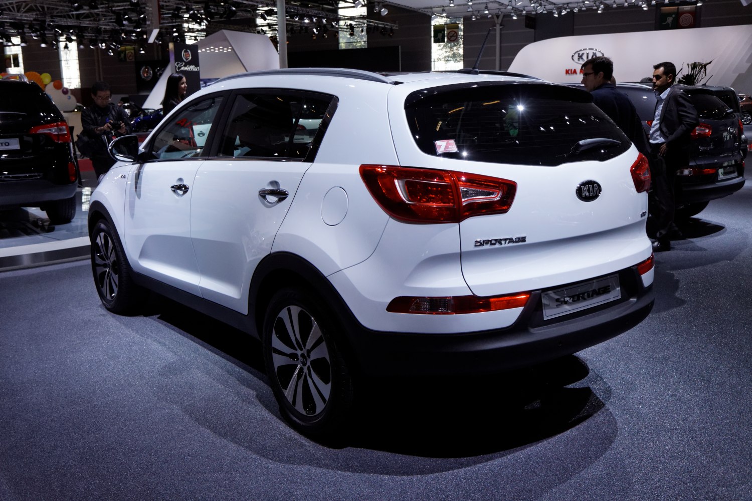 Rear and side view of white compact SUV with distinctive tail lights.