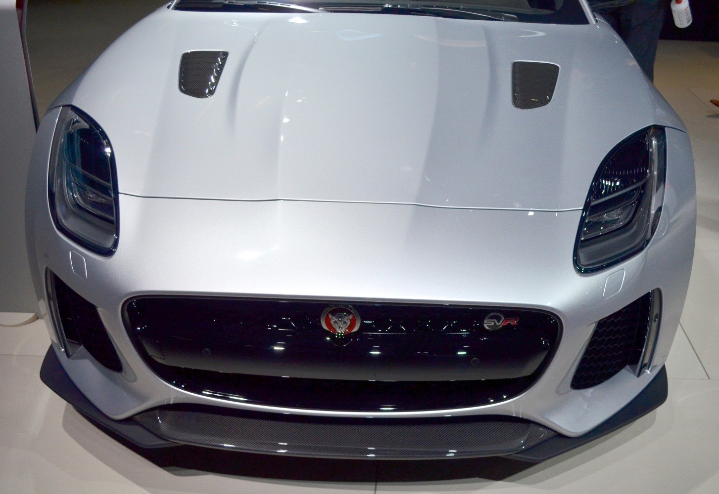Close-up of front grille, headlights, and SVR badge of a performance coupe