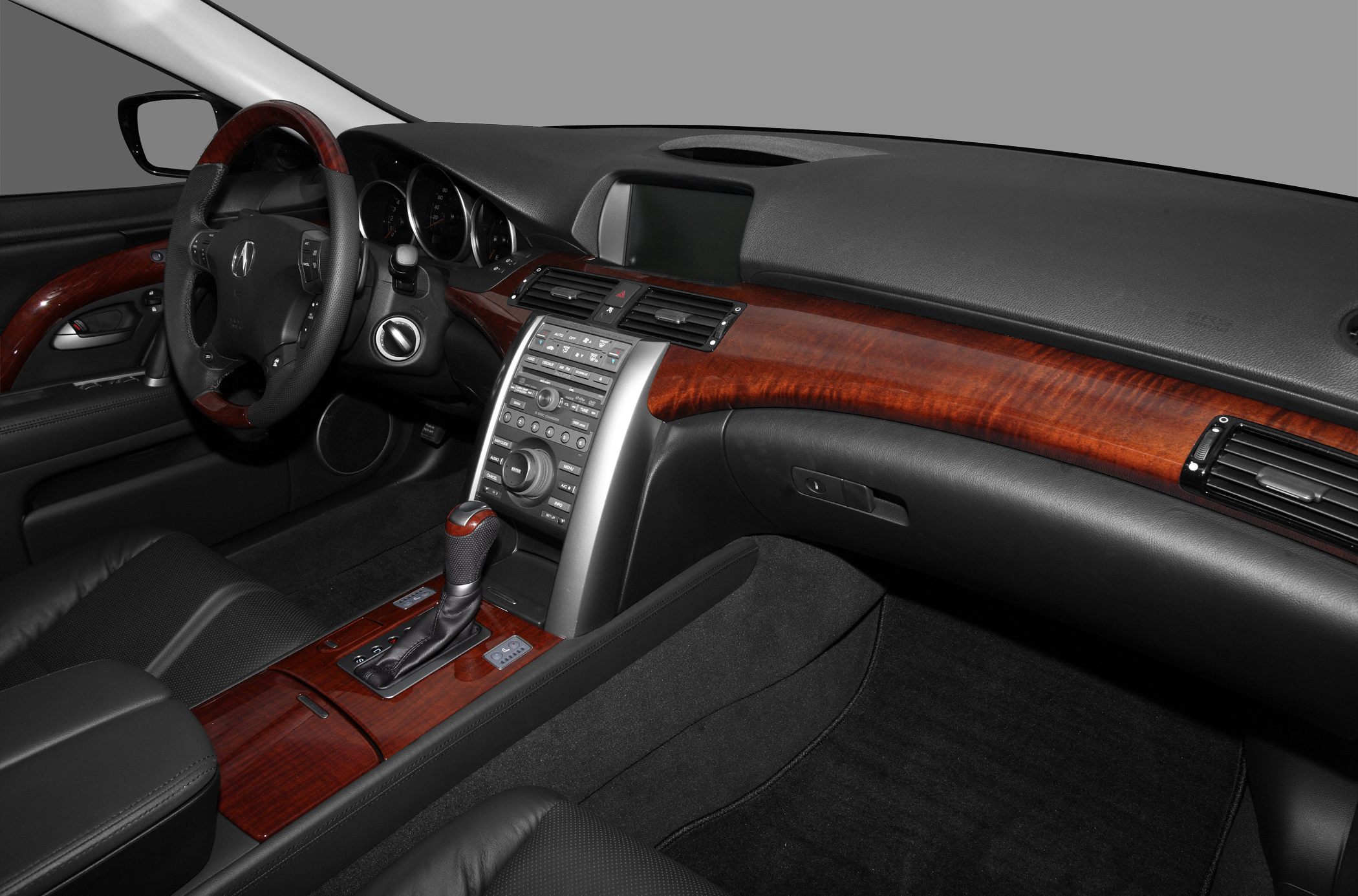 Luxury interior with wood trim, multifunction steering wheel, and automatic gear shifter