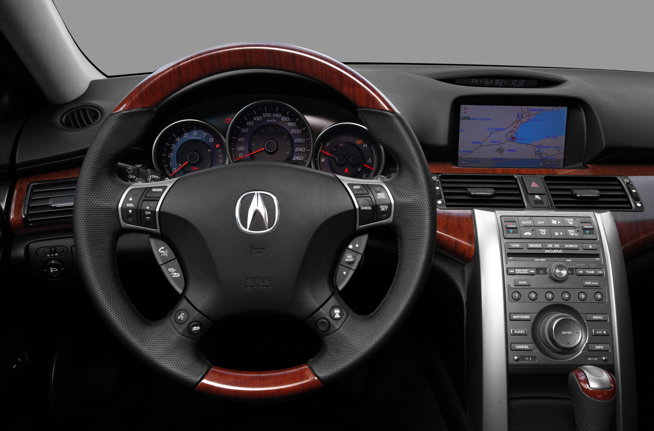 Wood-trimmed steering wheel and navigation dashboard with instrument cluster