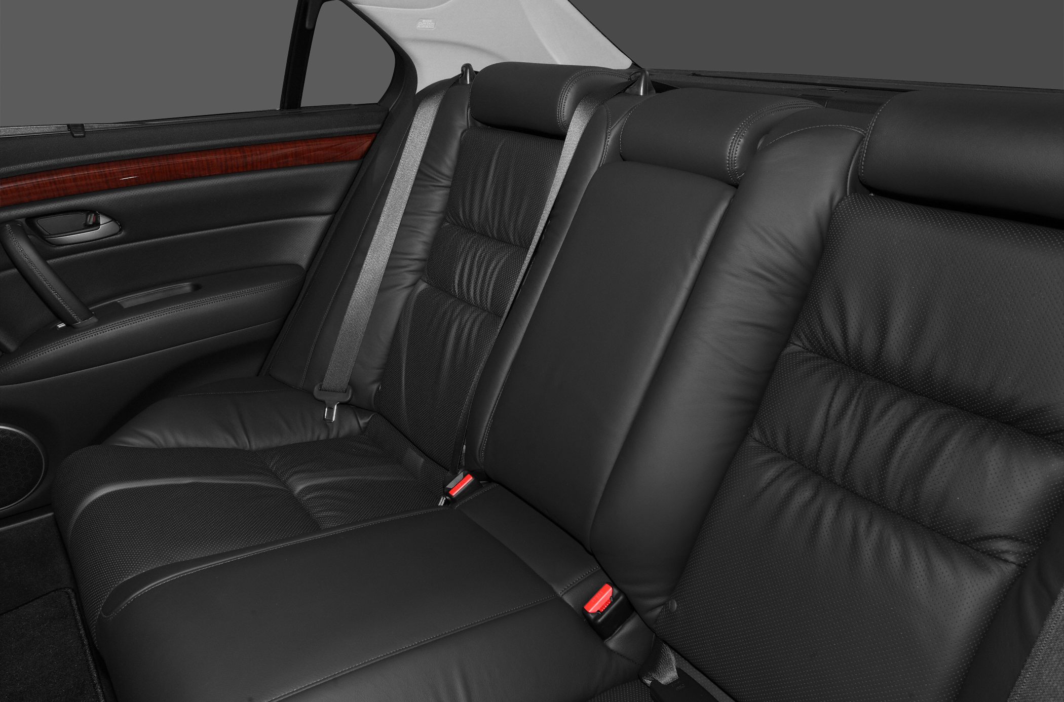 Black leather rear seats with plush cushioning and wood trim door panel