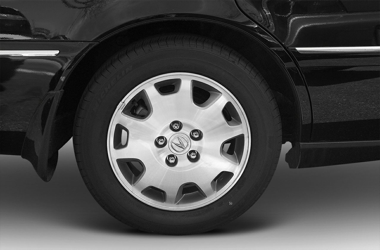 Close-up view of alloy wheel and tire with emblem center cap