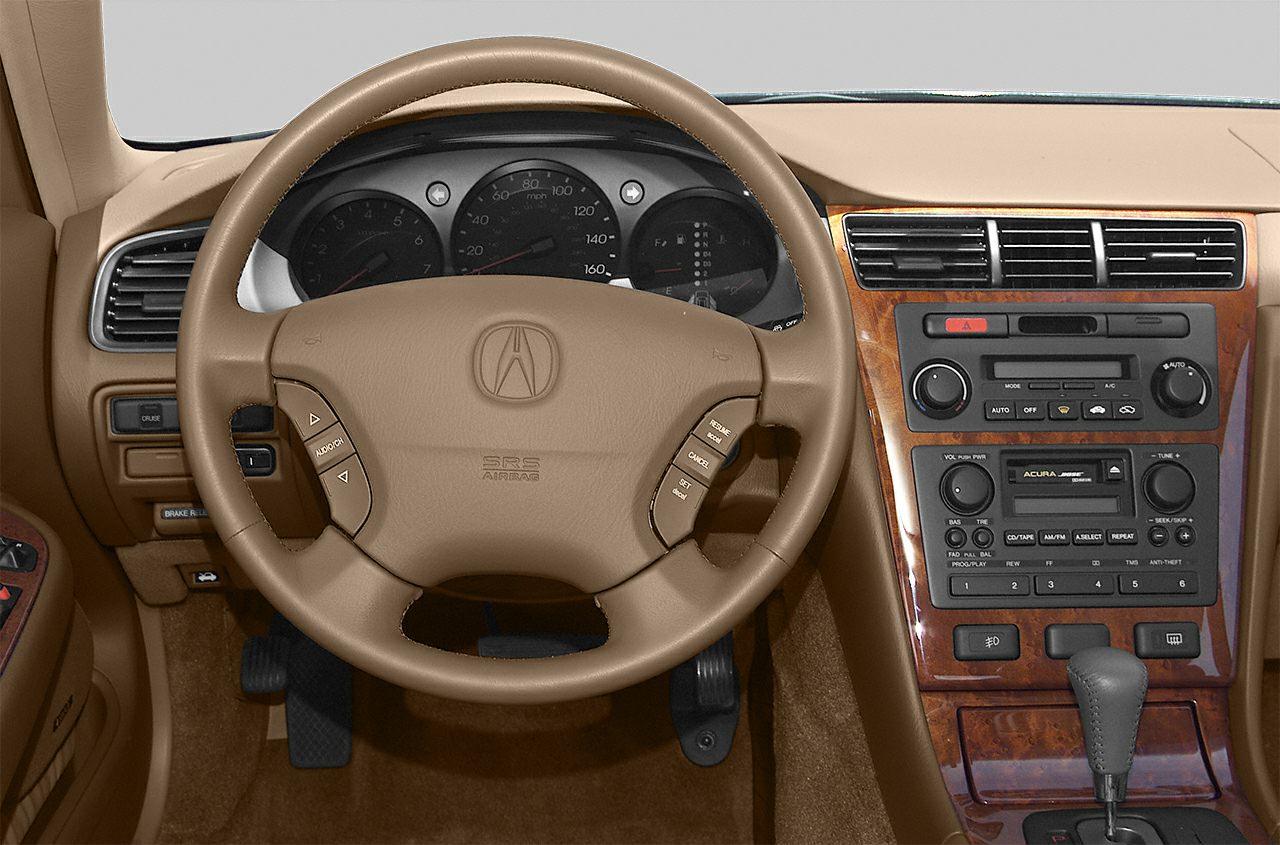 Steering wheel with controls and wood-trimmed dashboard with audio system