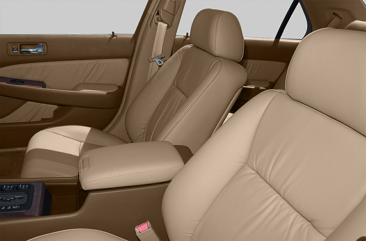 Beige leather front seats and door panel with wood trim and chrome handle