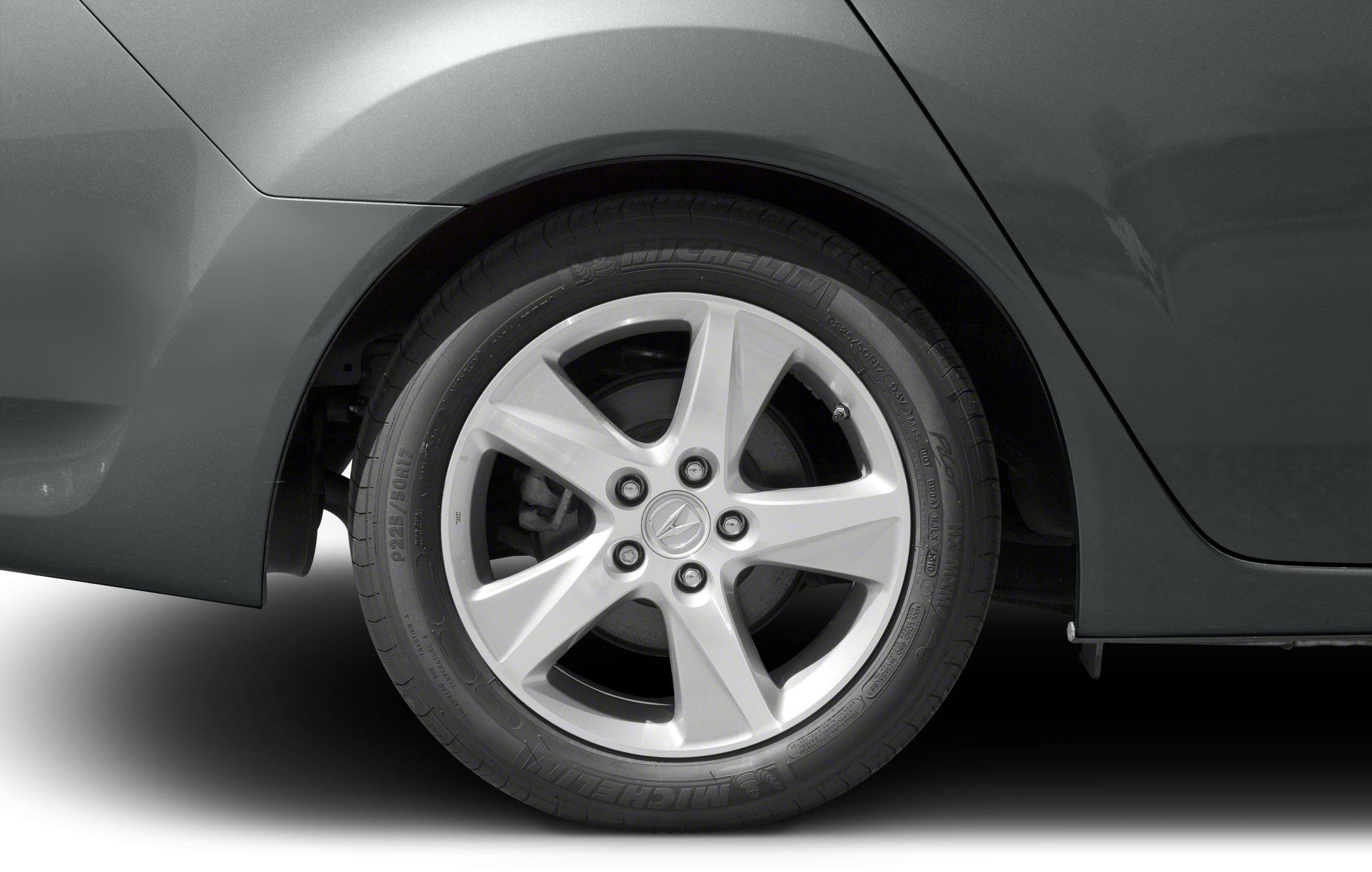 Close-up of rear wheel with 5-spoke alloy rim and Michelin tire.