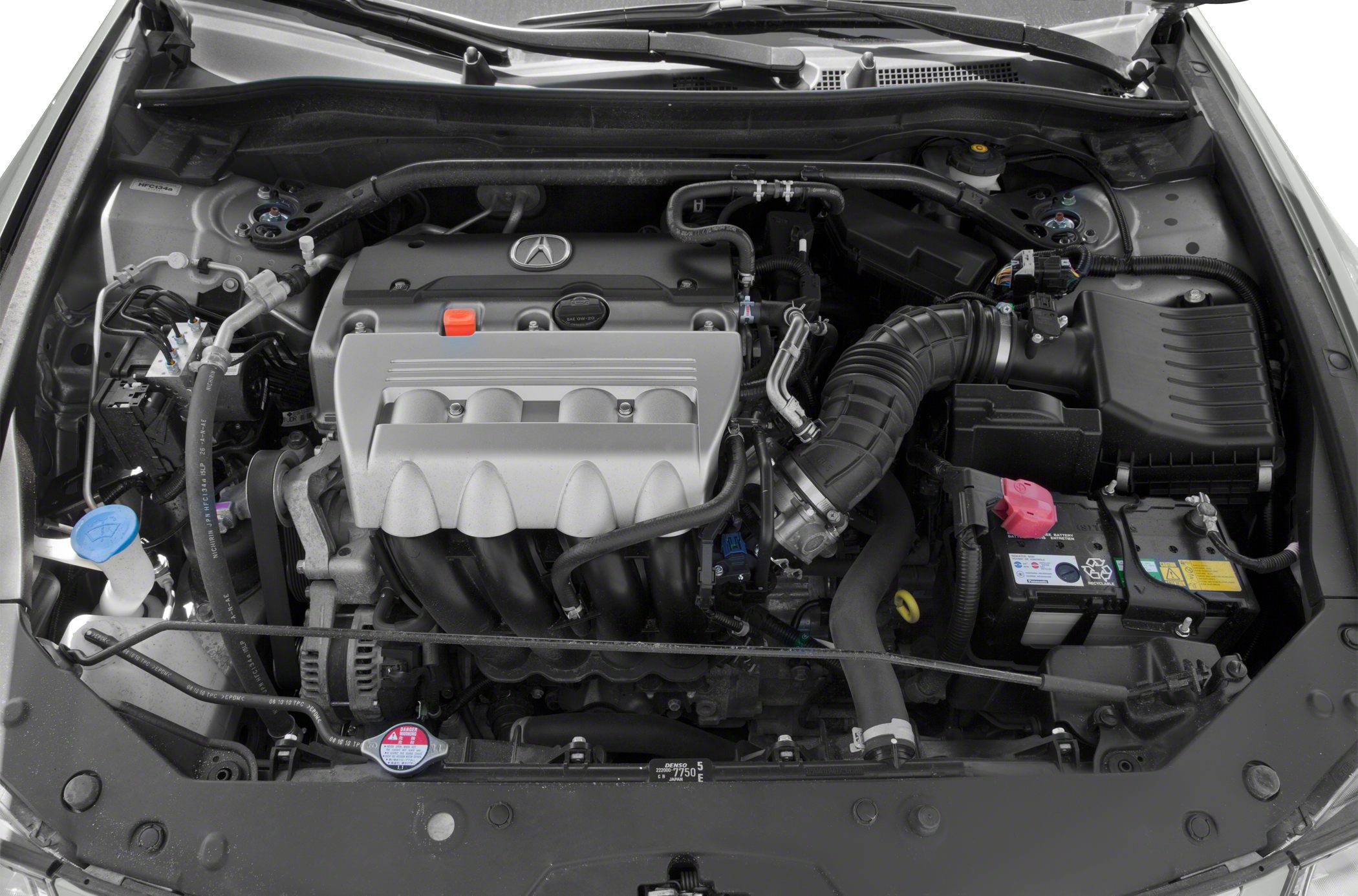 Close-up of an engine compartment with engine components and wiring.