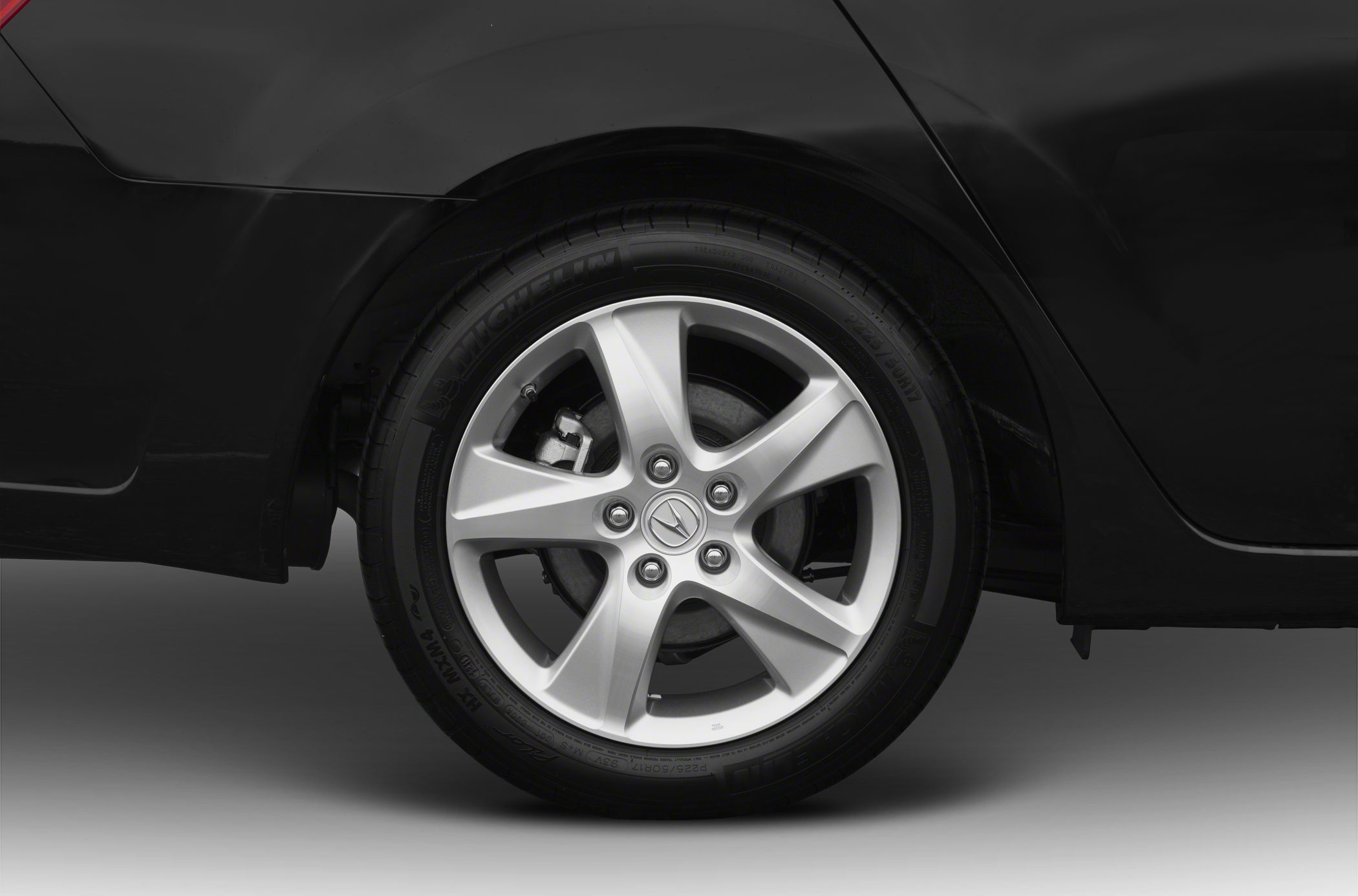 Close-up of silver alloy wheel with Acura logo and Michelin tire