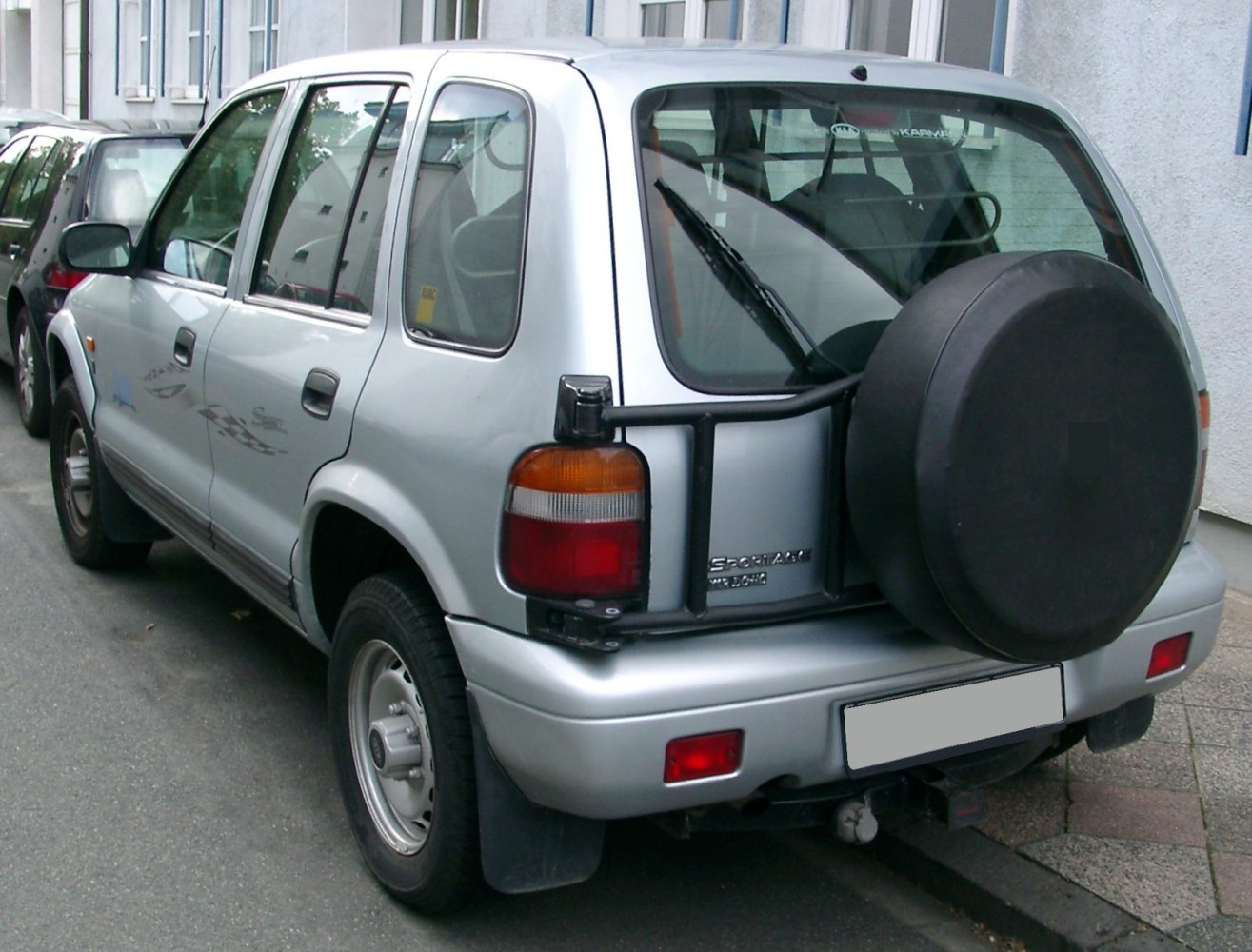 Rear view with external spare tire and classic tail light assembly