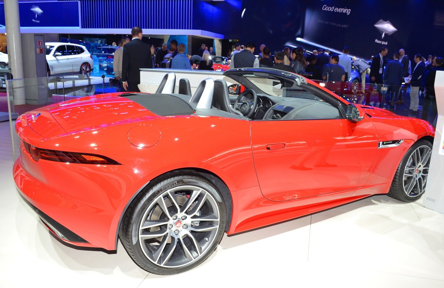 Red convertible with open top, alloy wheels, and sleek rear lights