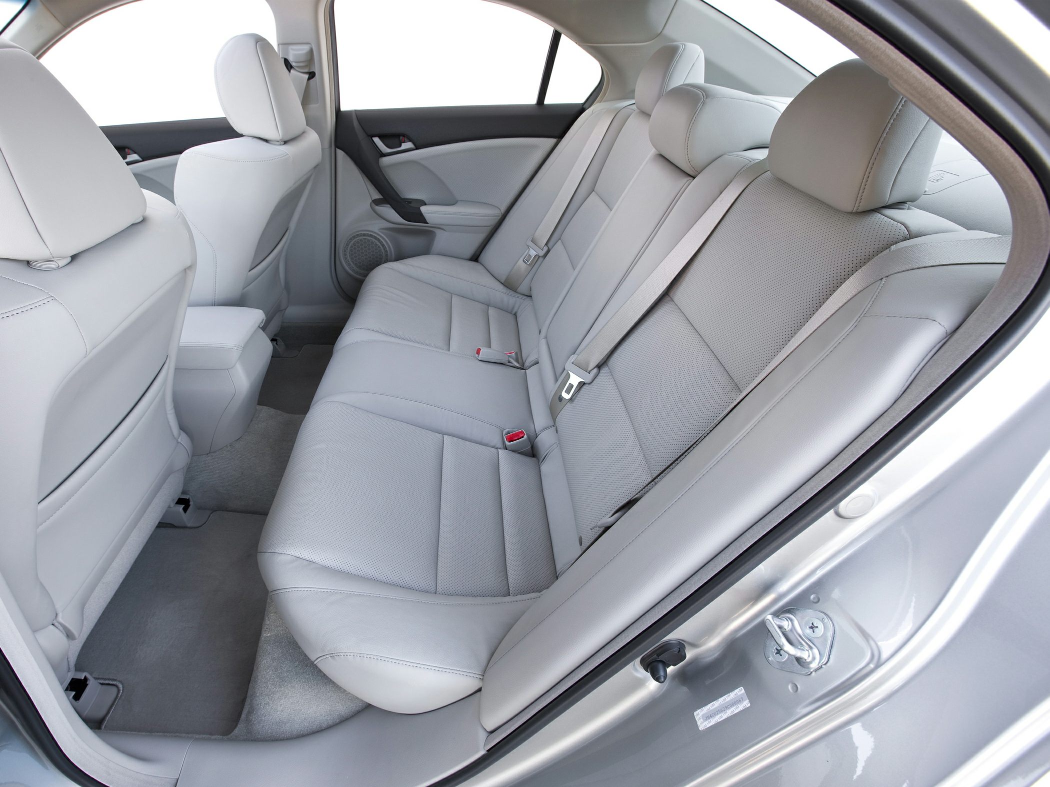 Light grey leather rear seats with spacious passenger area and door panel.