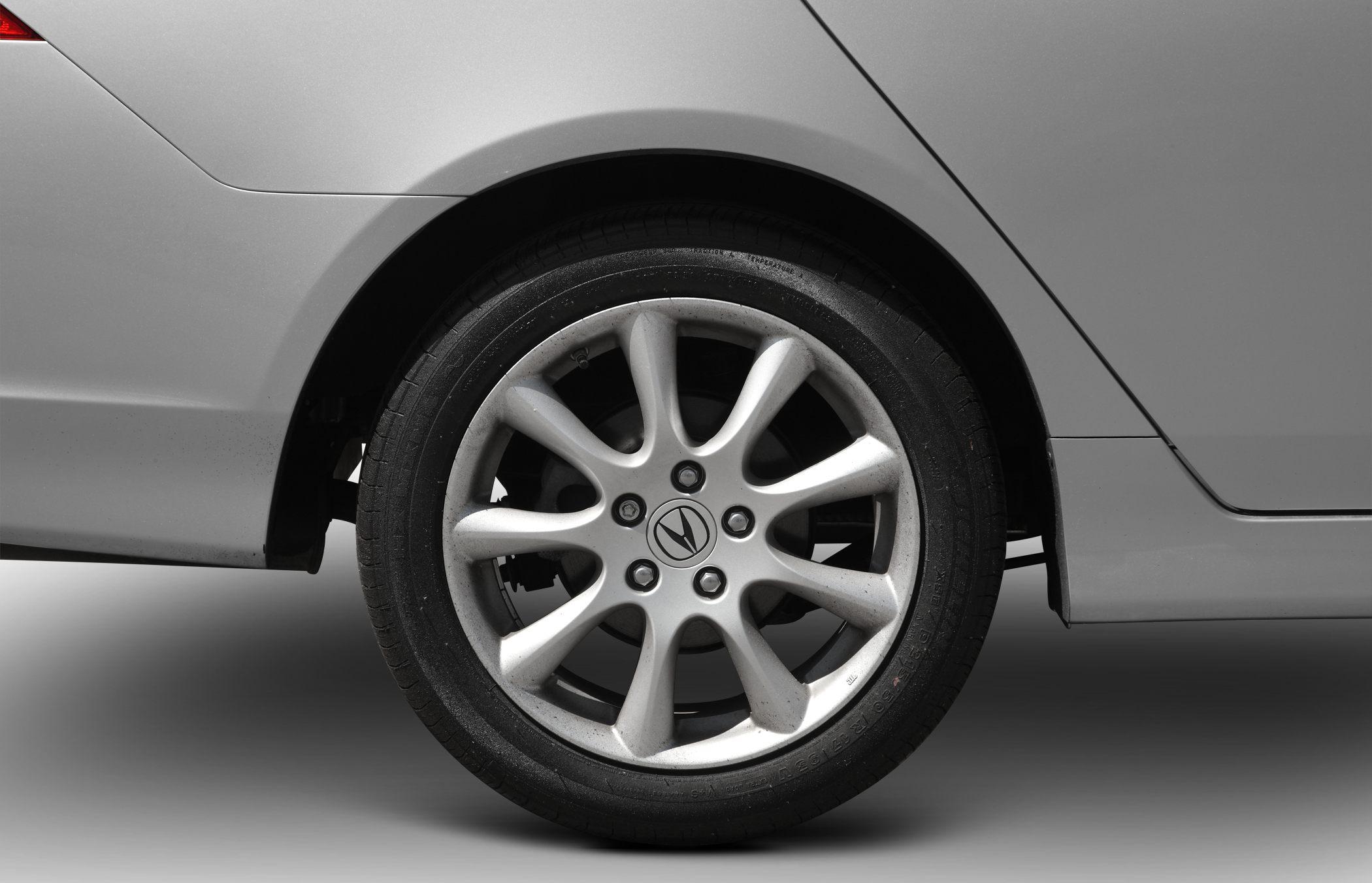 Silver alloy multi-spoke wheel and rear quarter panel