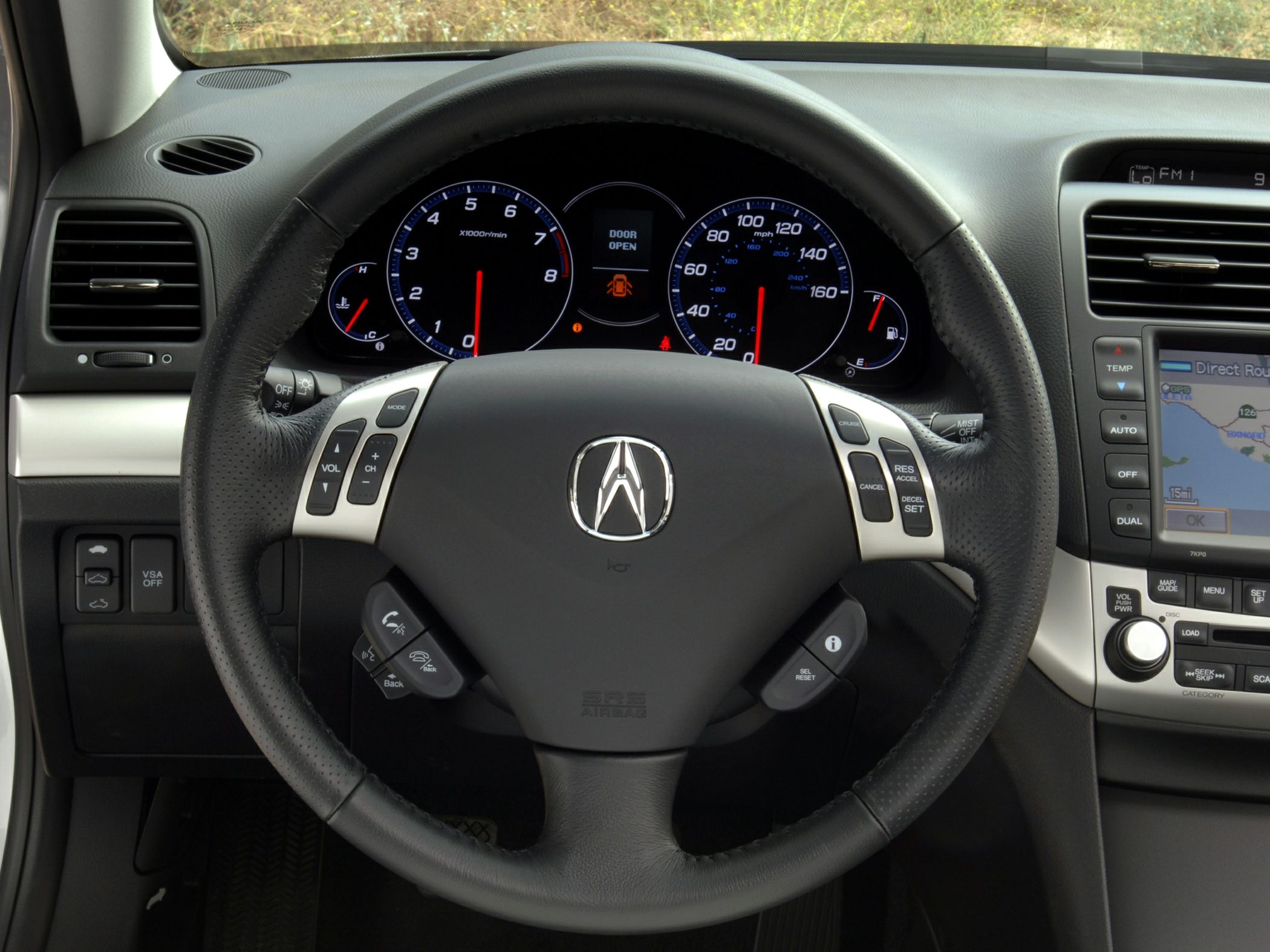 Steering wheel with control buttons and instrument cluster with gauges