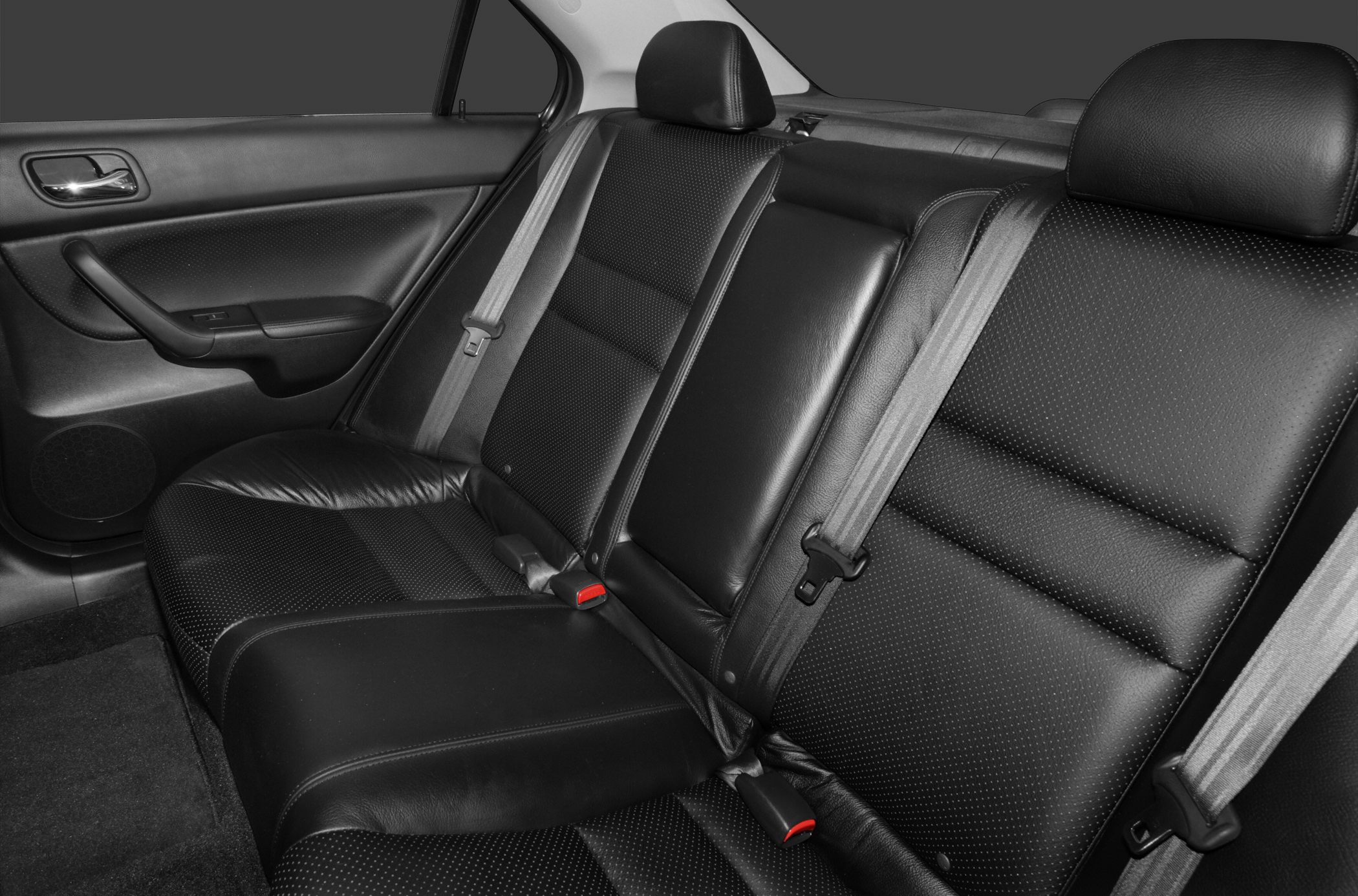 Black leather rear seats with seat belts and door panel.