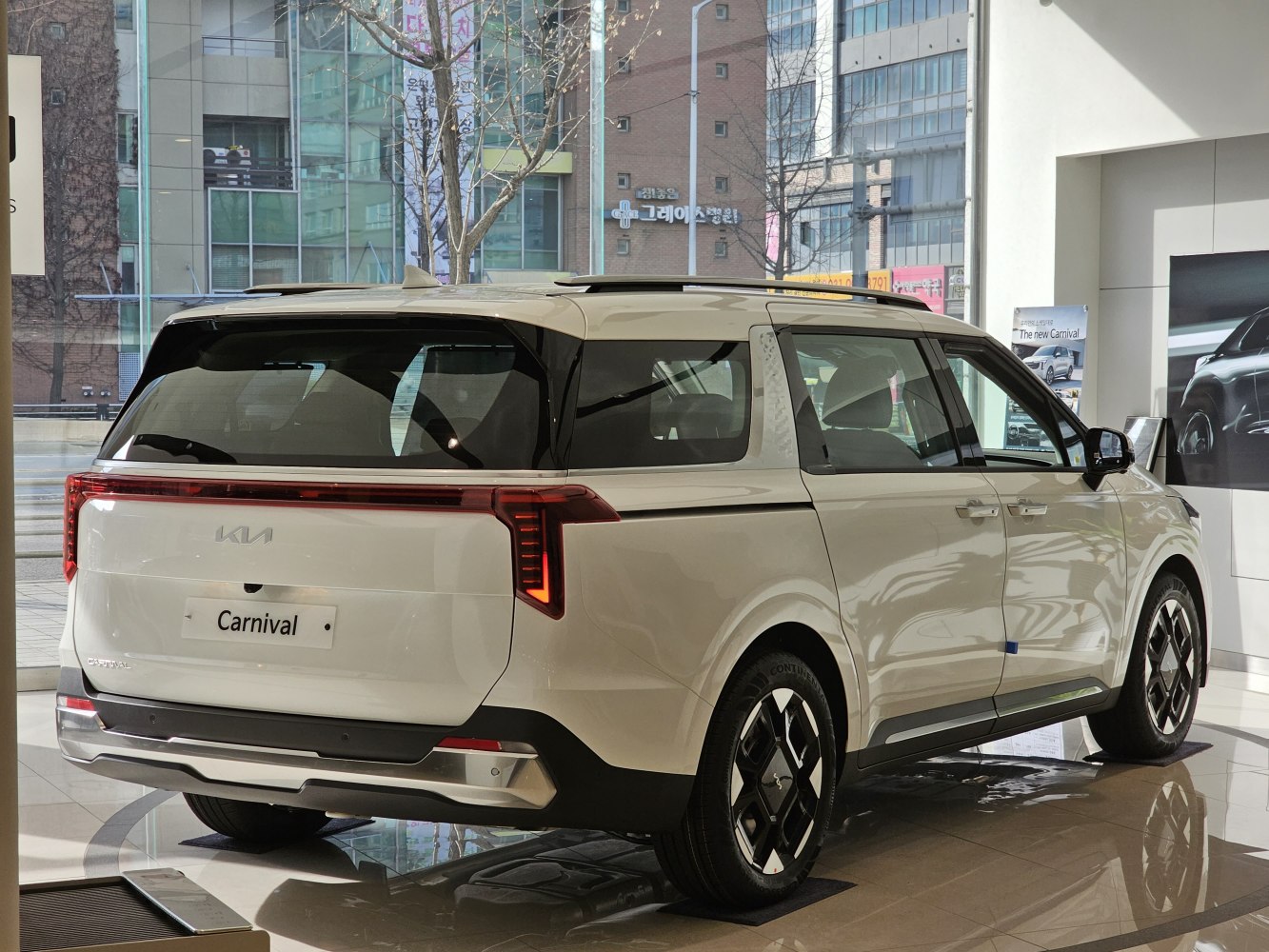 Rear view of modern minivan with sleek tail light design and large windows