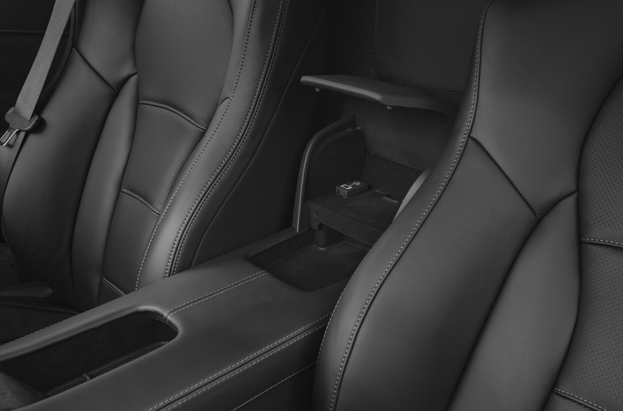 Leather bucket seats and center console with armrest and stitching