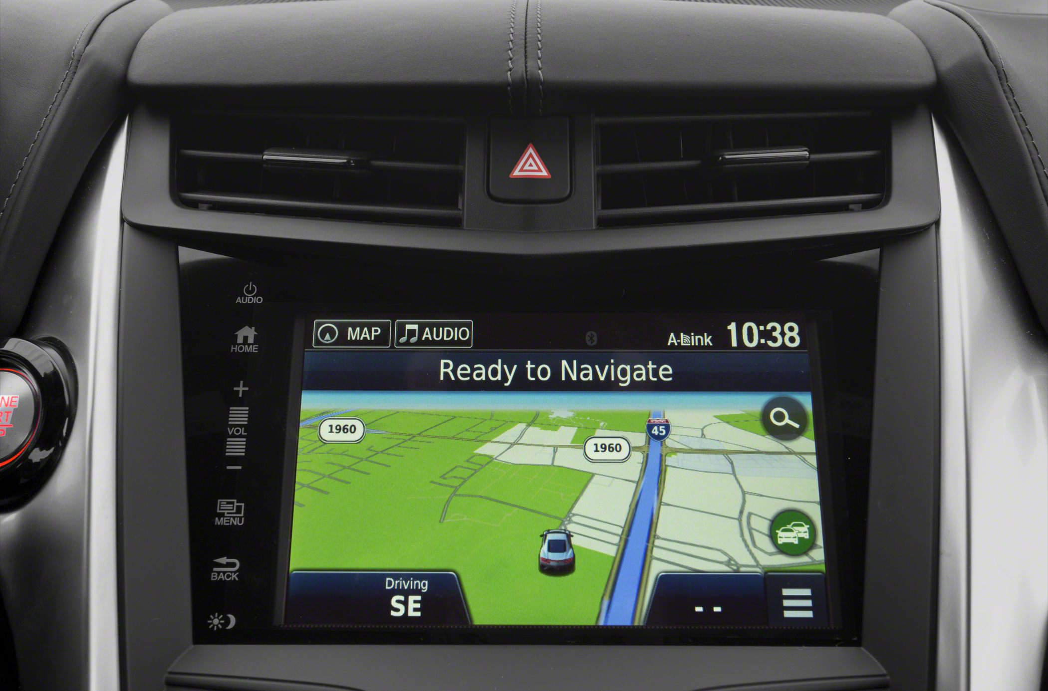In-car touchscreen navigation system with map display and control buttons.
