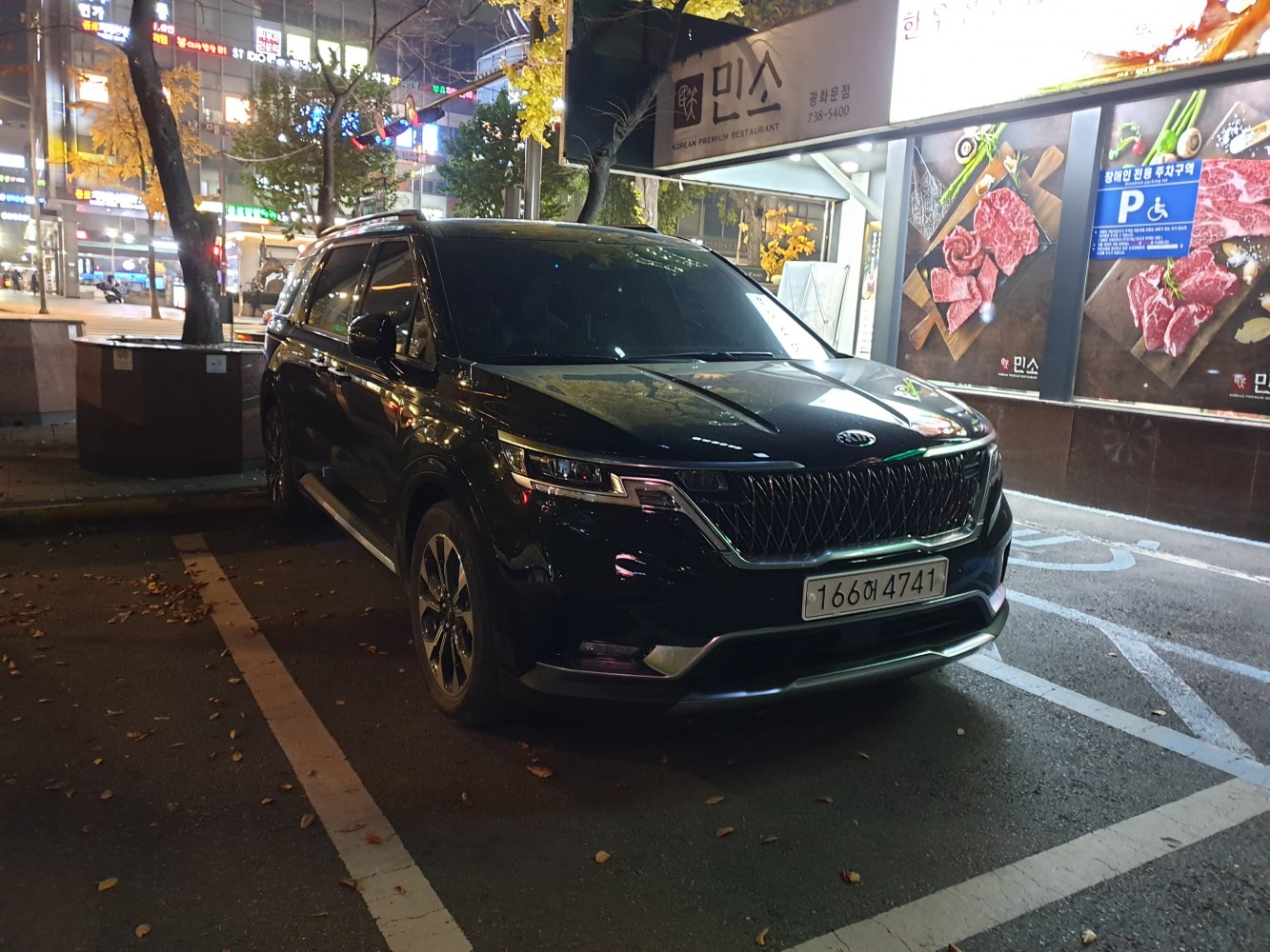 Front and side exterior of a modern SUV with LED headlights at night
