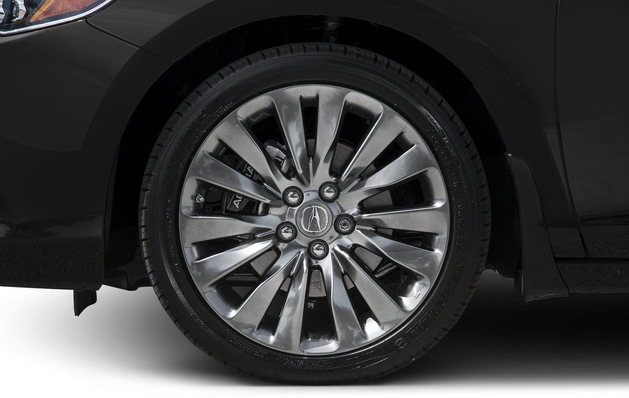 Close-up of alloy wheel with brake caliper and tire on vehicle.