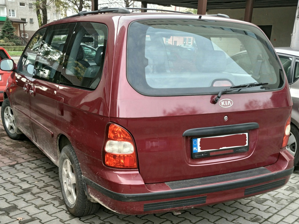 Rear exterior view with tail lights and large rear window.