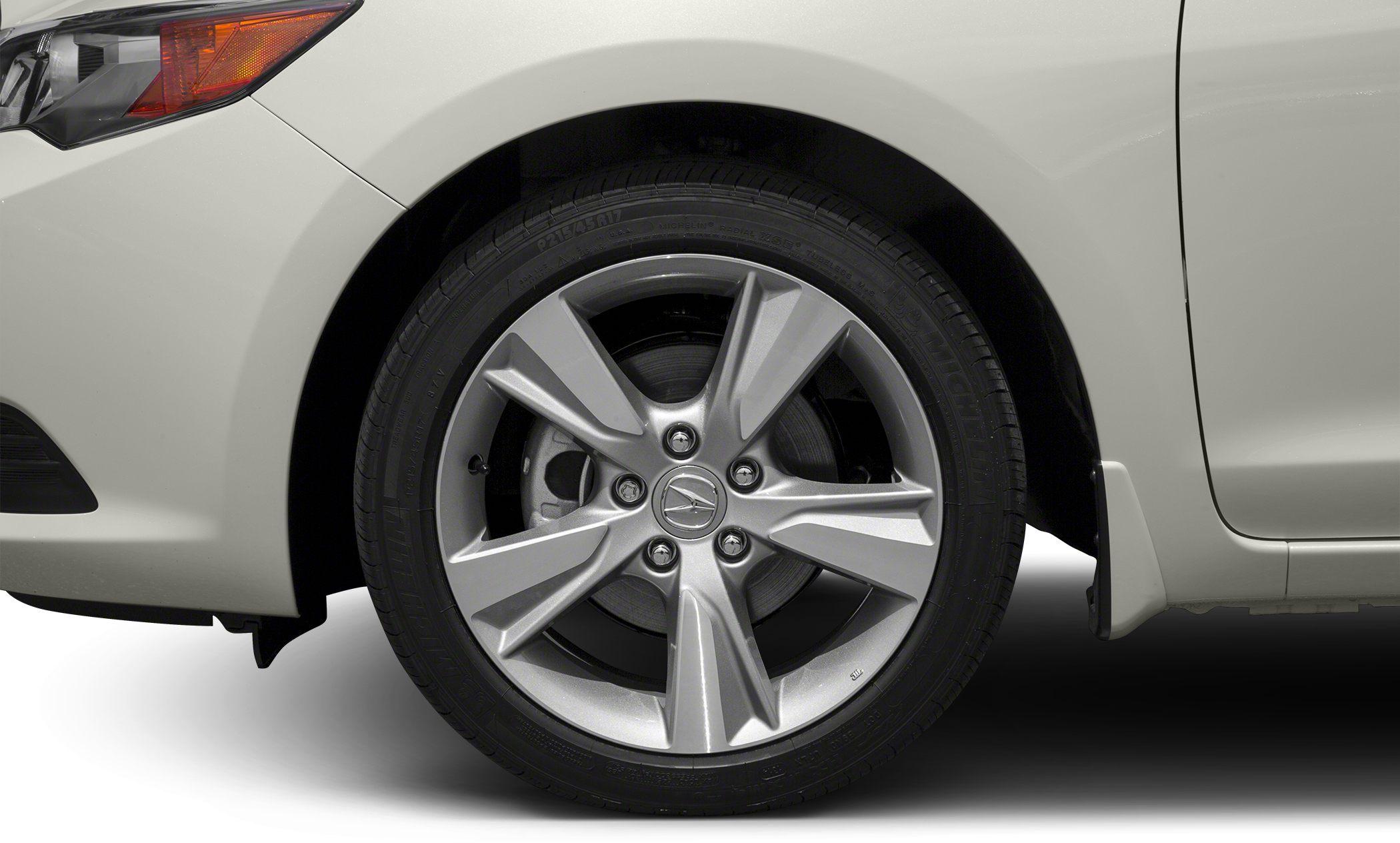 Alloy wheel and front fender close-up with detailed tire tread