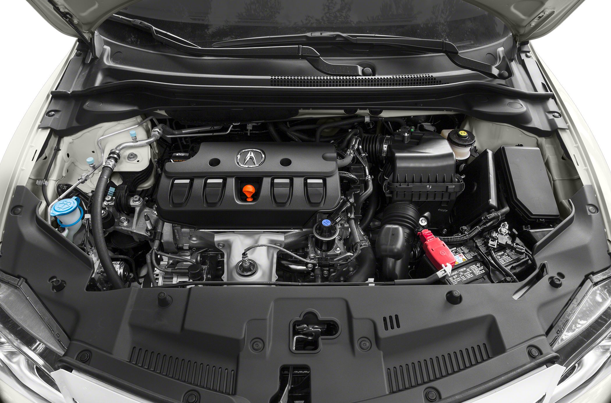 Close-up of car engine bay with visible engine cover, battery, and fluid reservoirs