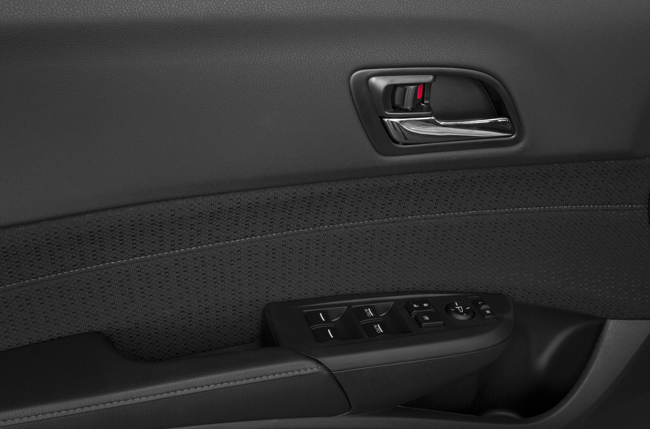 Interior door panel with window controls and door handle.