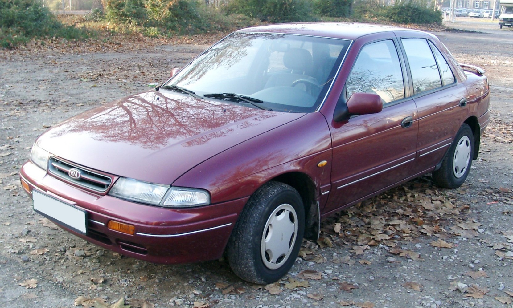 Compact sedan with hubcaps and front-side view