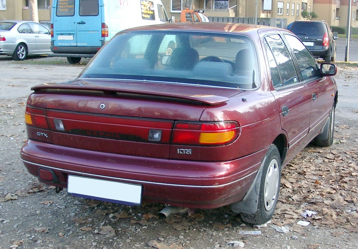 Rear sedan with spoiler and distinct tail light arrangement