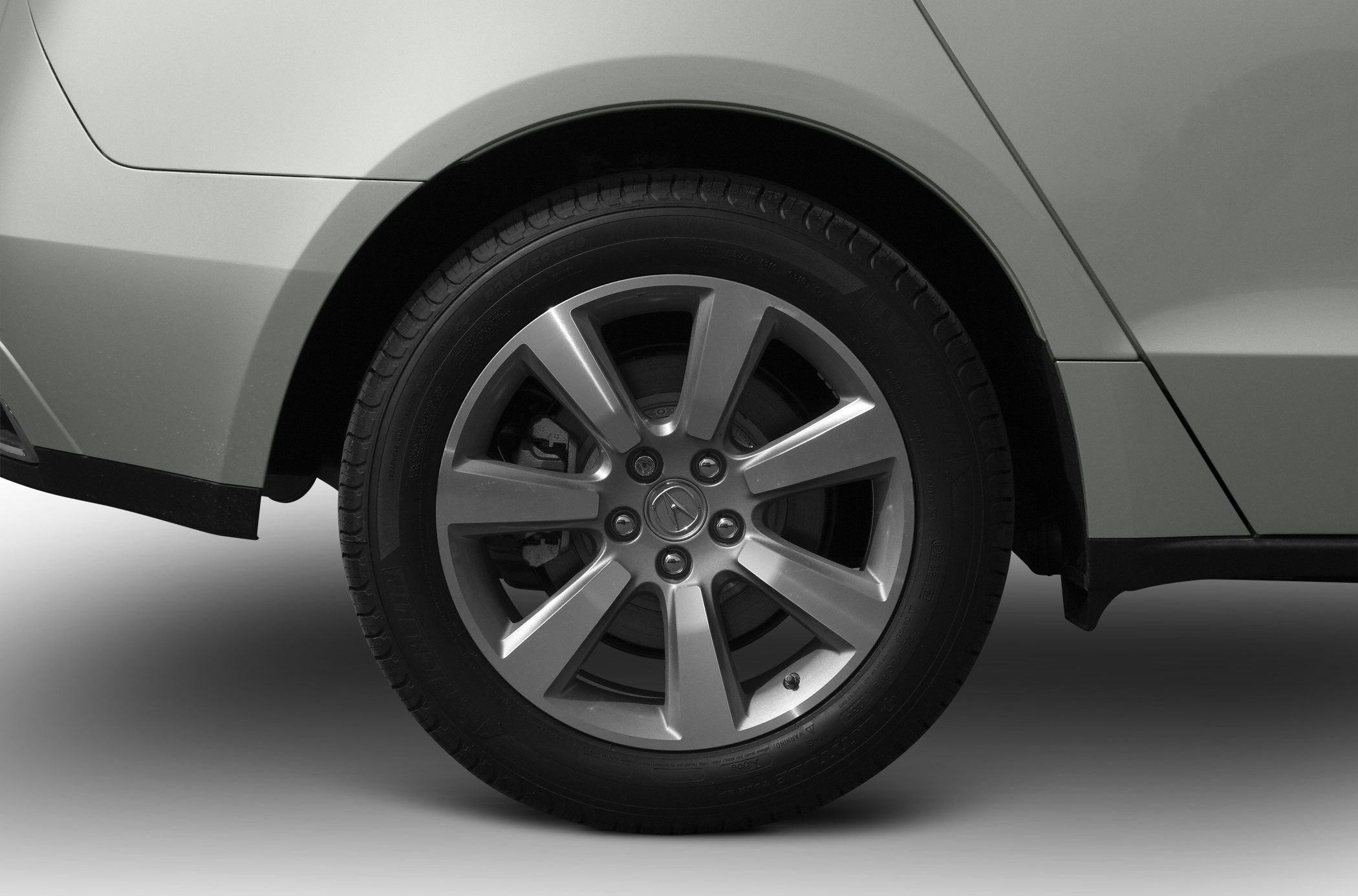Close-up of alloy wheel and tire with visible spokes and tread.
