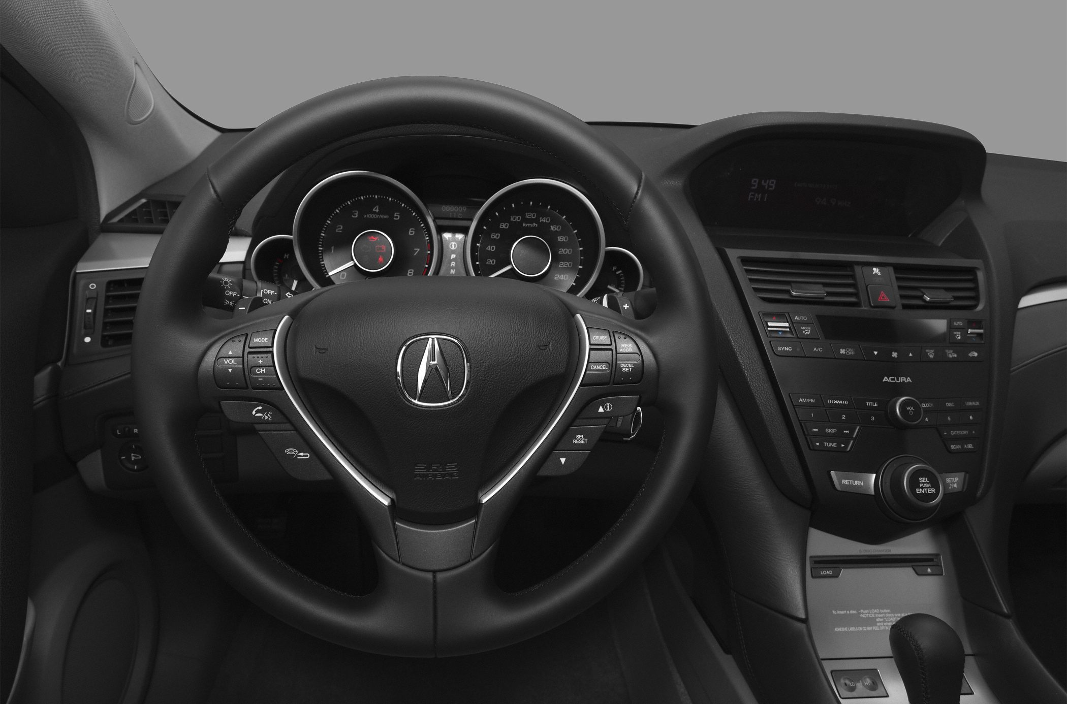 Steering wheel with controls and dashboard including instrument cluster and infotainment system.