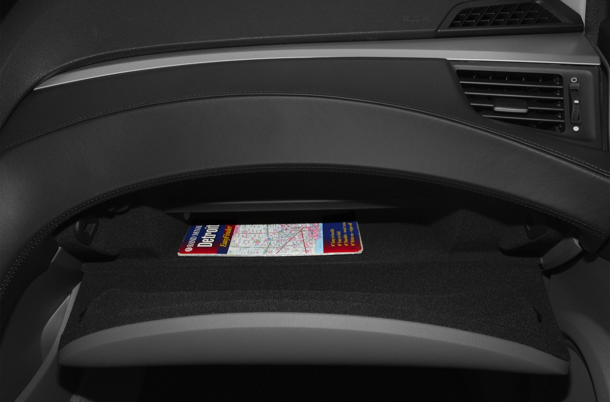 Black glove compartment with map inside