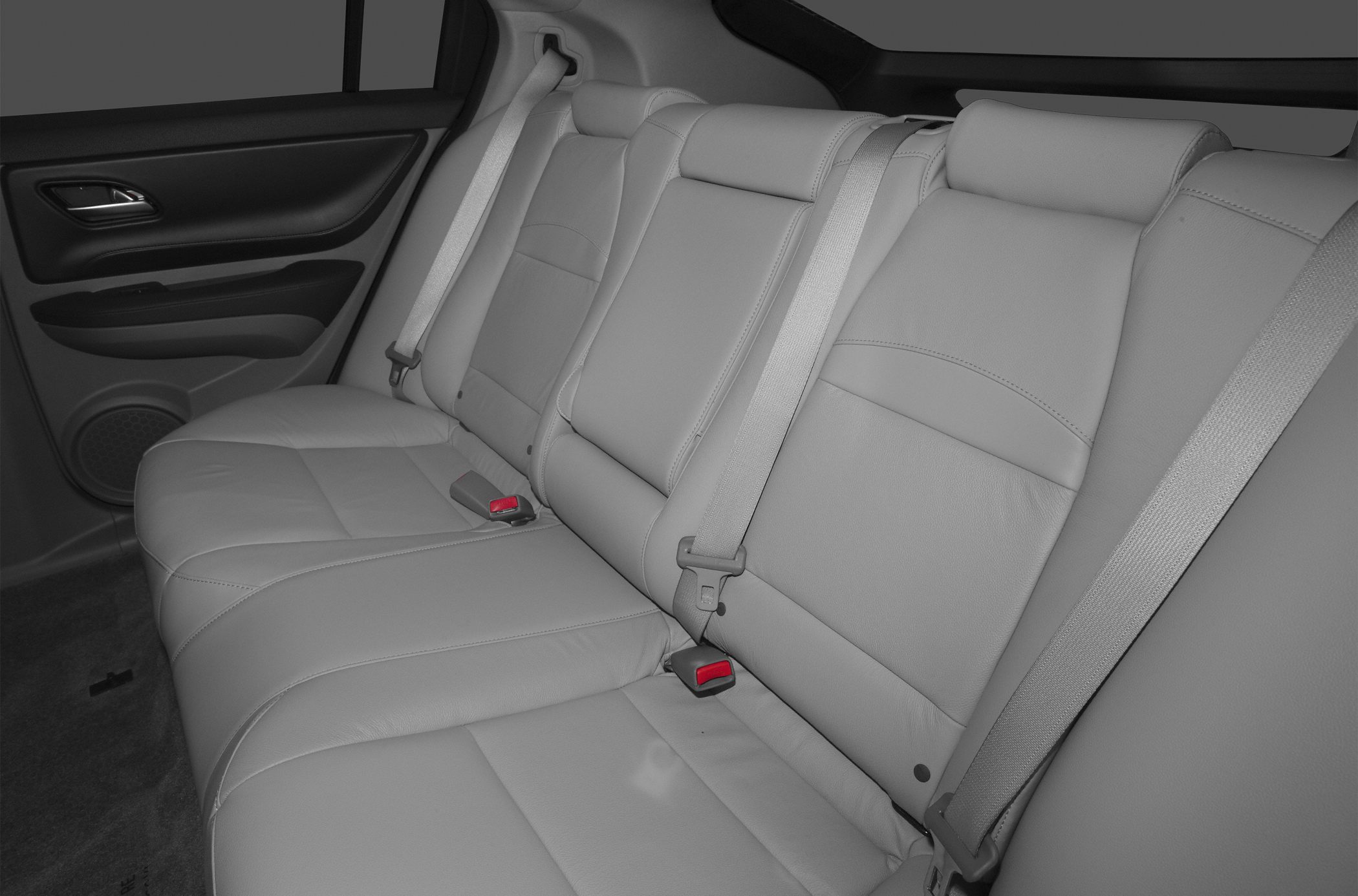 Premium leather rear seats with seatbelts and door panel in SUV interior