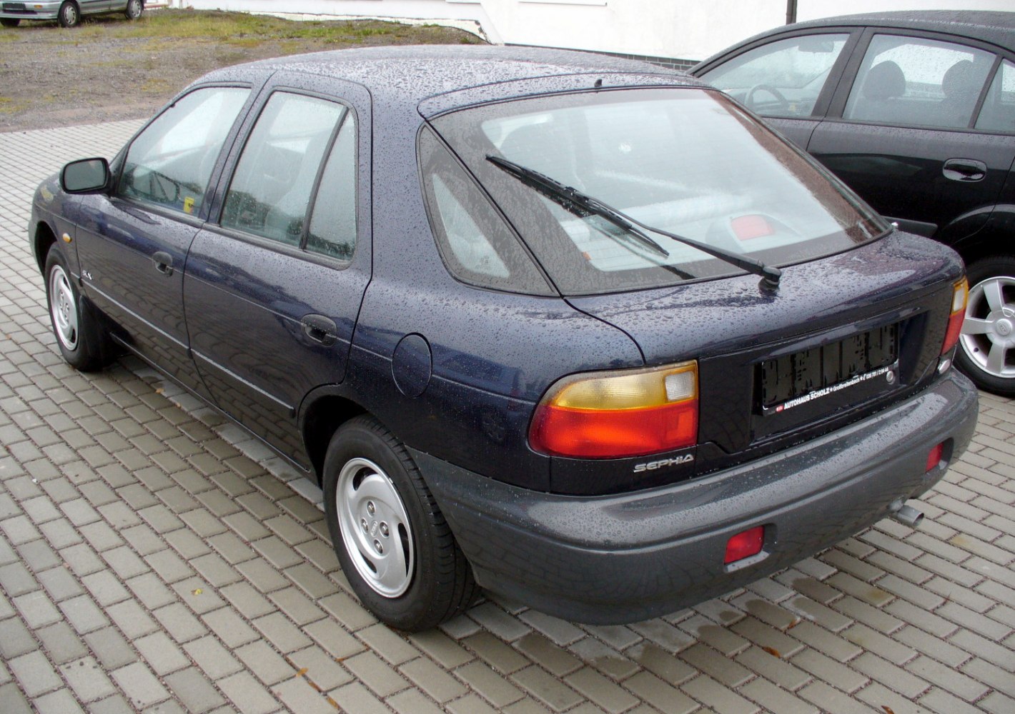 Rear and side view of classic hatchback with rear wiper and distinctive lights