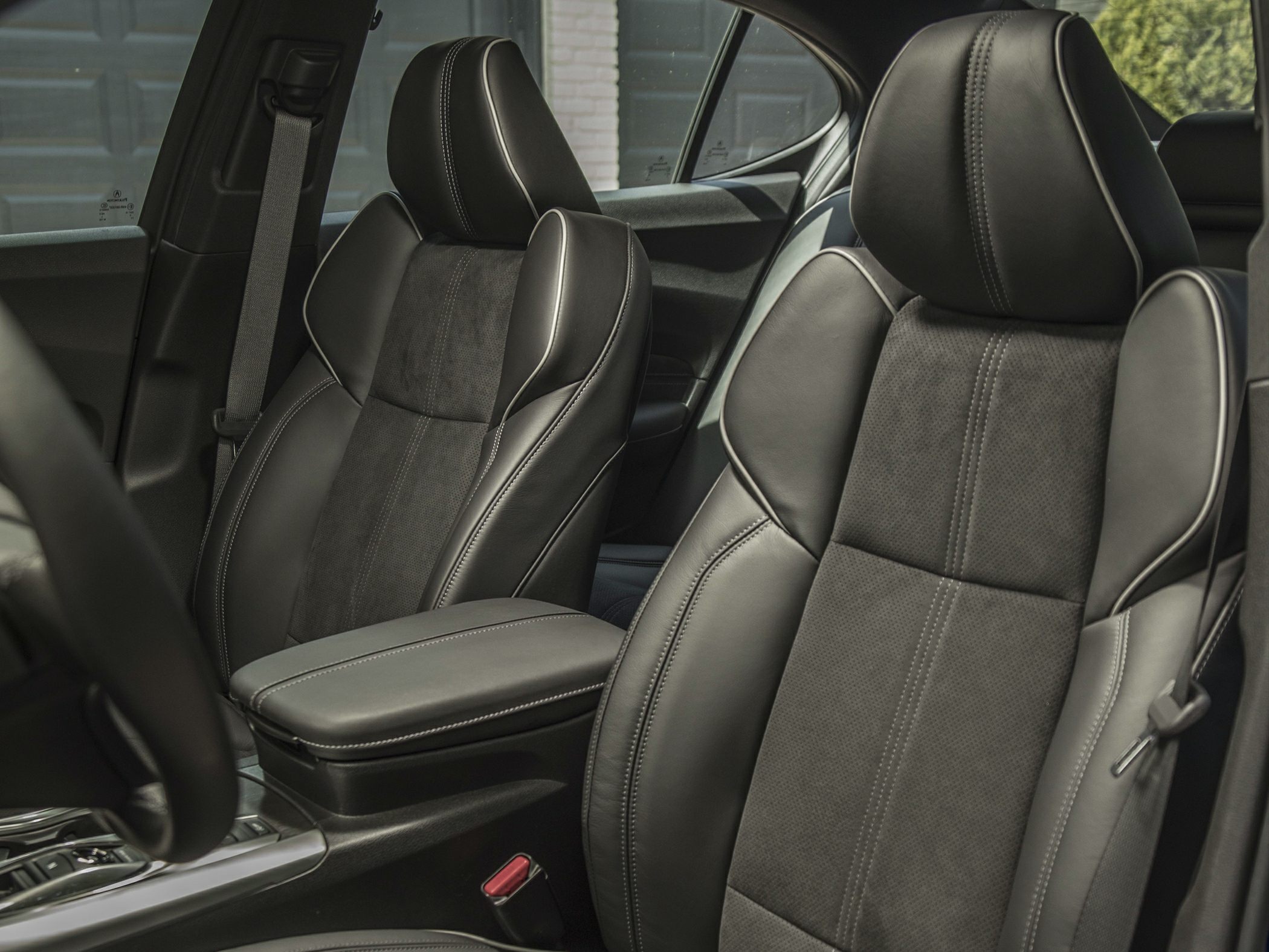 Leather and Alcantara front seats with detailed stitching and central armrest