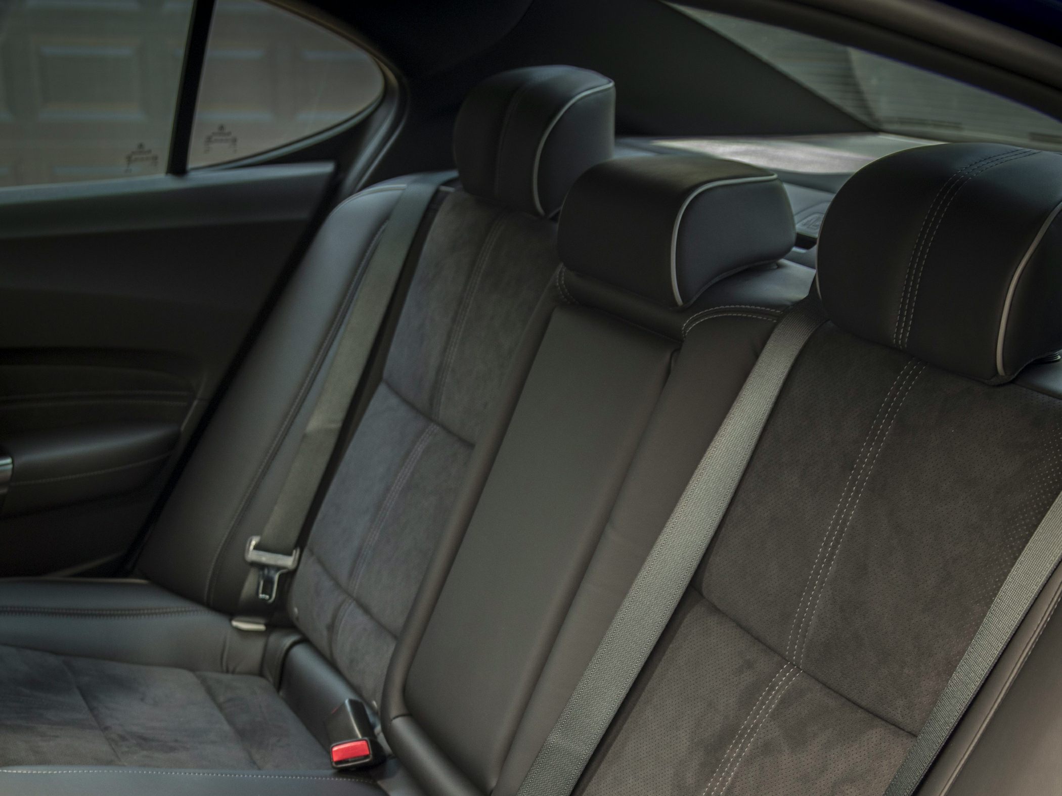 Rear seat interior with black leather upholstery and headrests